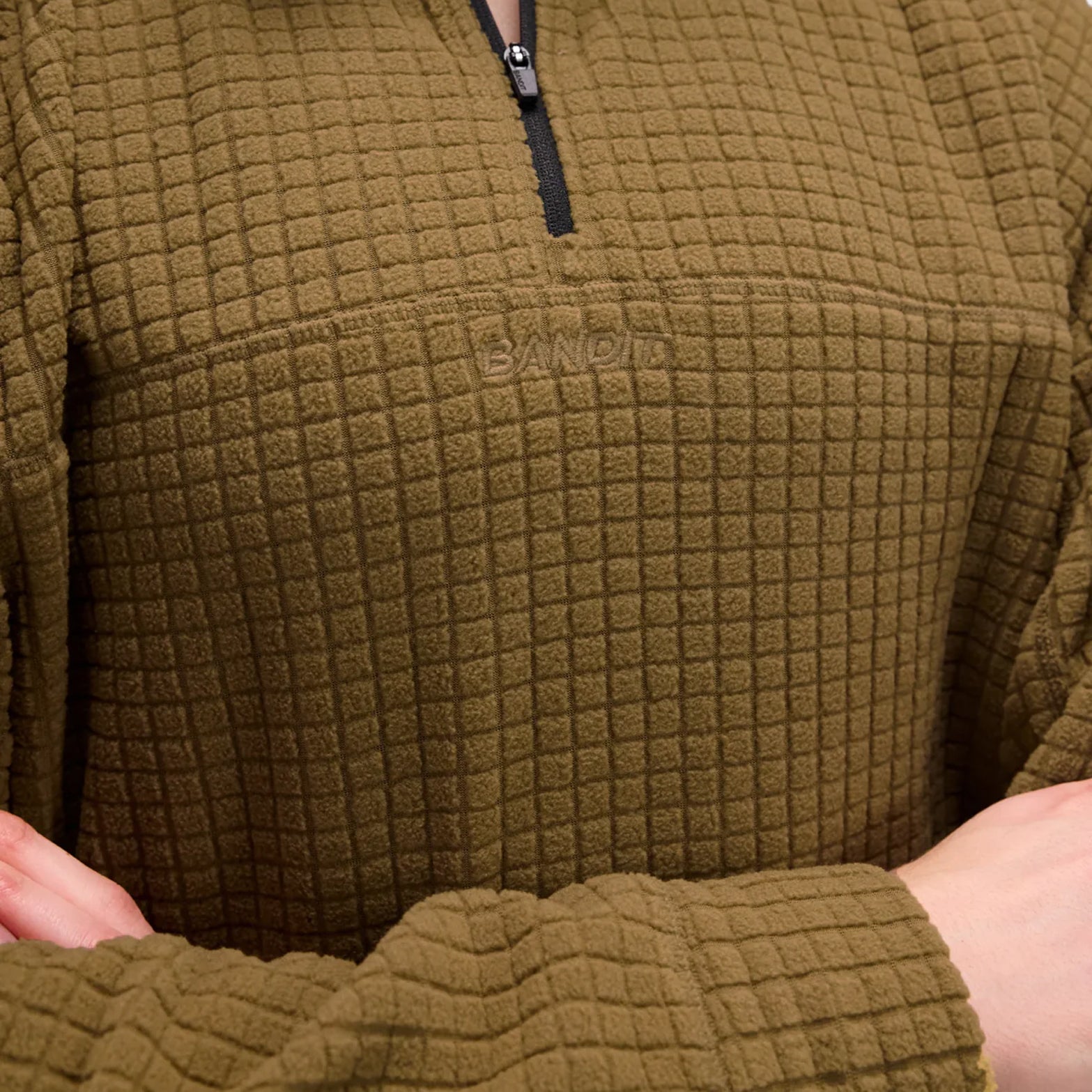 Bandit Quarter Zip front closeup showing quarter zip detail and embroidered logo