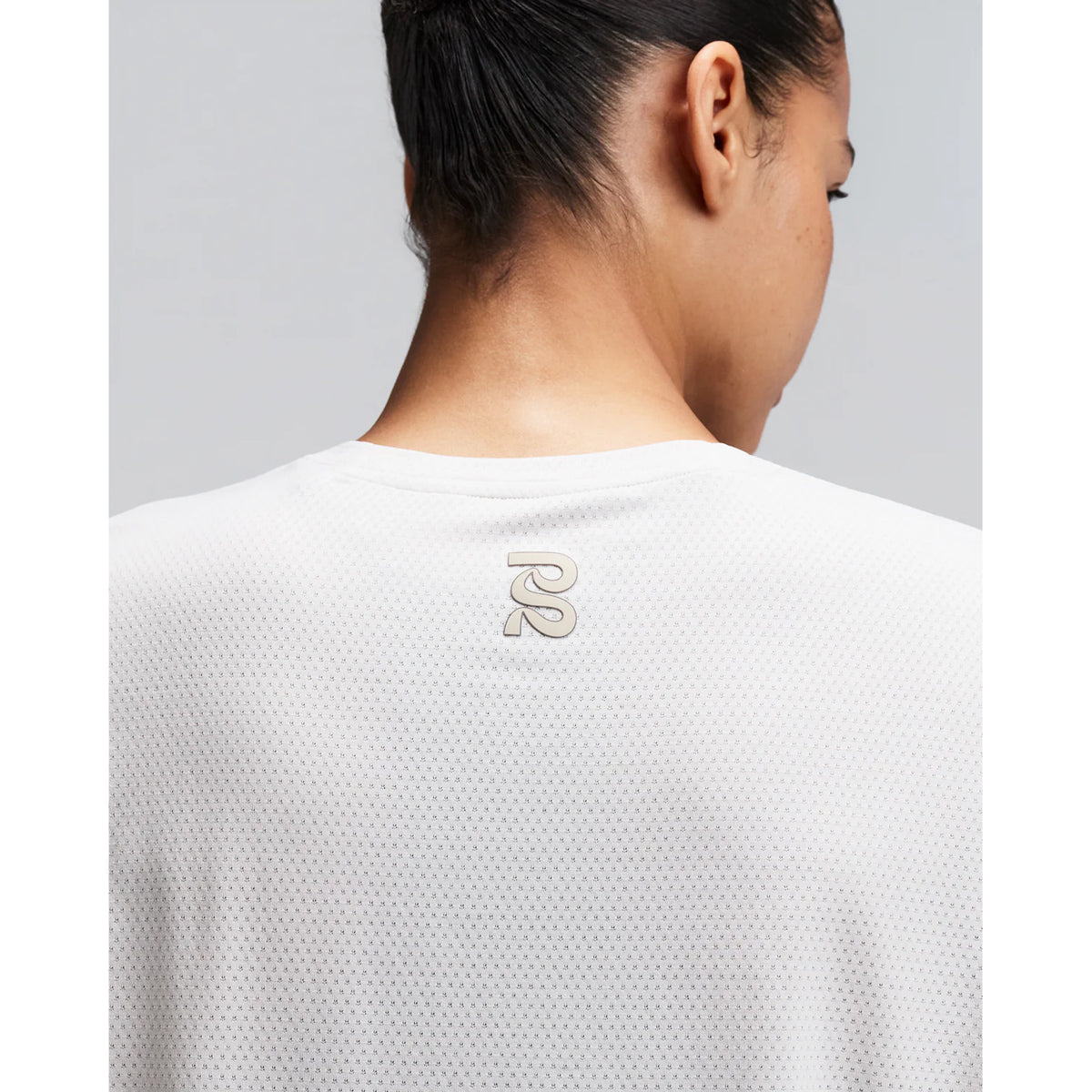 Women's Bandit Micromesh Cropped Run Tee Plaster close-up of back showing fast-drying Micromesh fabric with sweat-wicking airflow construction for sustained running efforts