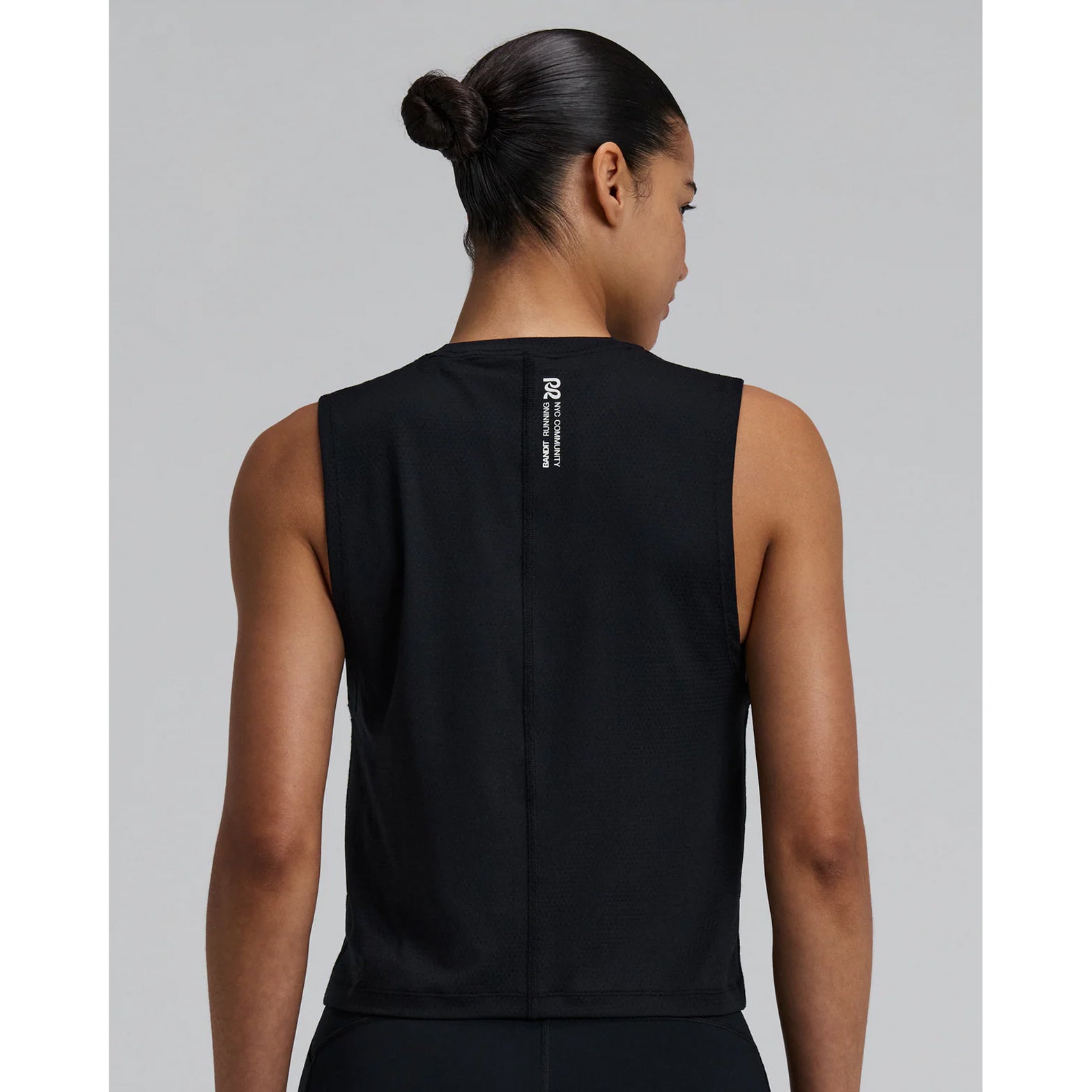 Bandit Micromesh Run Tank women's in Black — back view worn on model showing relaxed sleeveless silhouette, flatlock seam at centre back and Micromesh™ breathable fabric construction