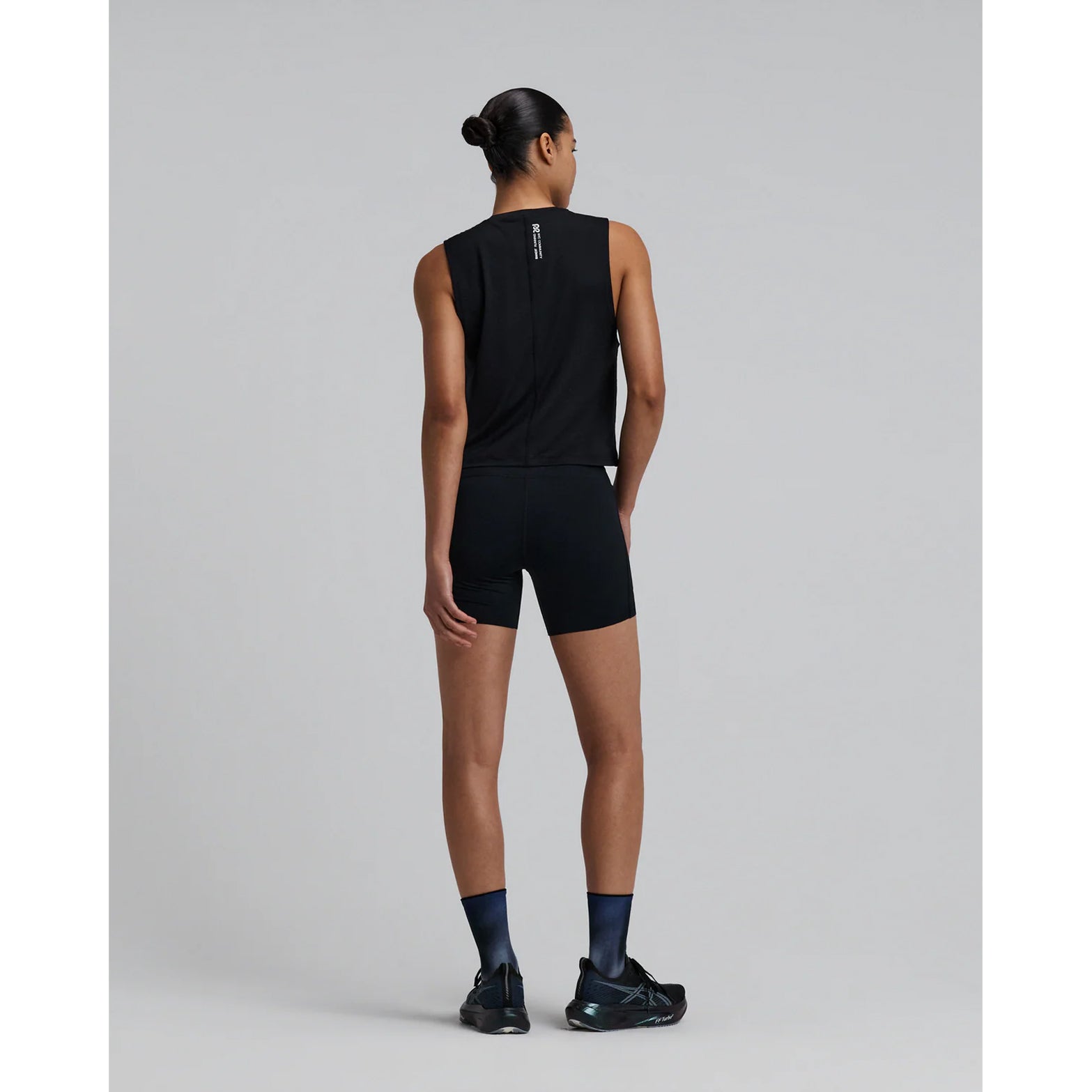 Bandit Micromesh Run Tank women's in Black — full body back view worn on model showing sleeveless relaxed silhouette, flatlock seam at centre back and Micromesh™ breathable fabric construction