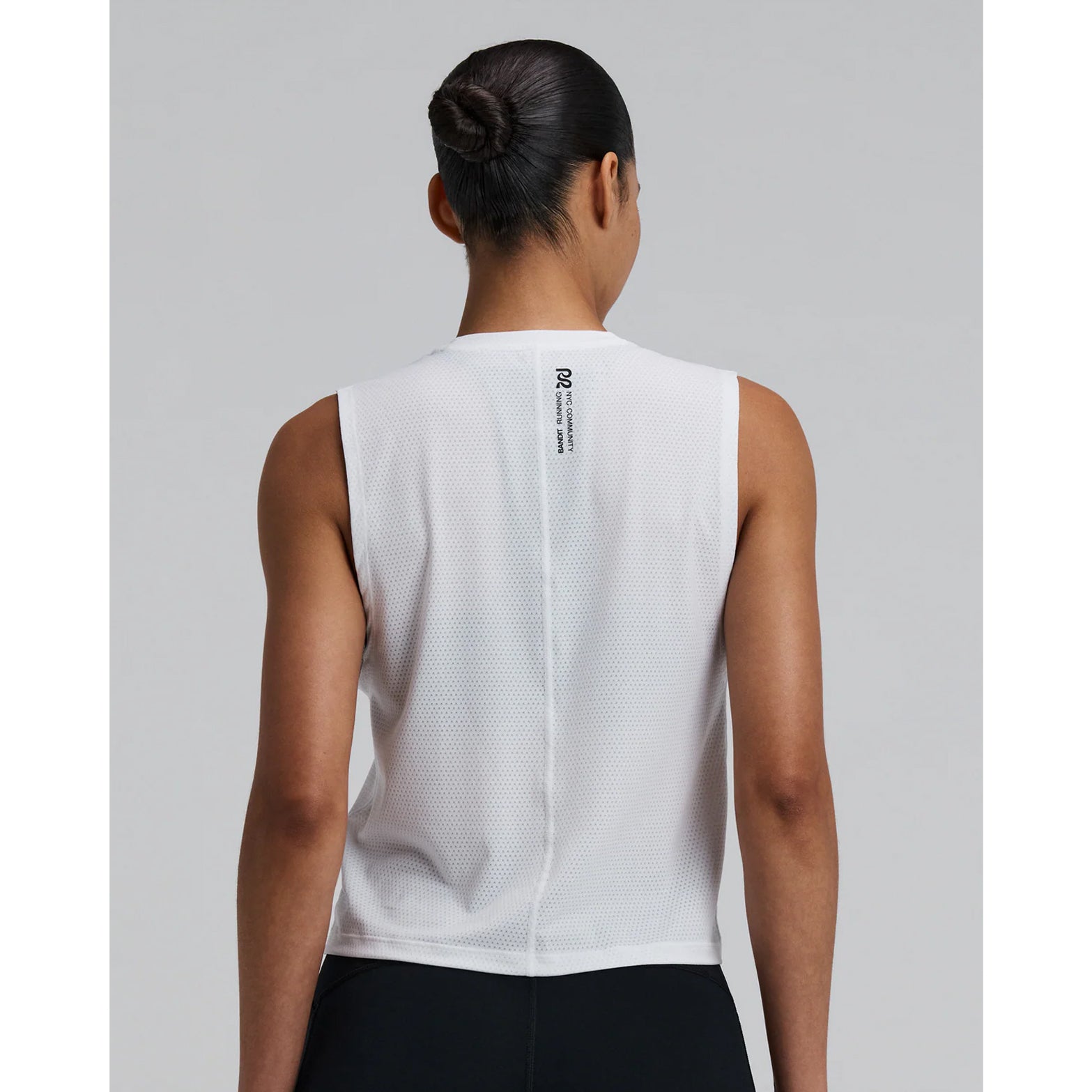 Bandit Micromesh Run Tank women's in White — back view worn on model showing relaxed sleeveless silhouette, flatlock seam at centre back and Micromesh™ breathable fabric construction

