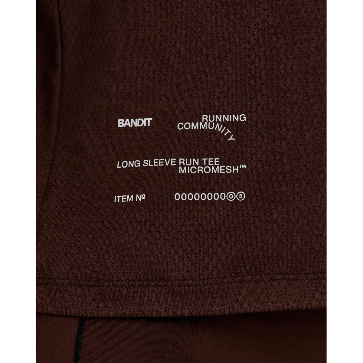 Women's Bandit Micromesh Top Cacao close-up of reflective graphics at centre front and back plus reflective infographic at front hem for low-light running visibility