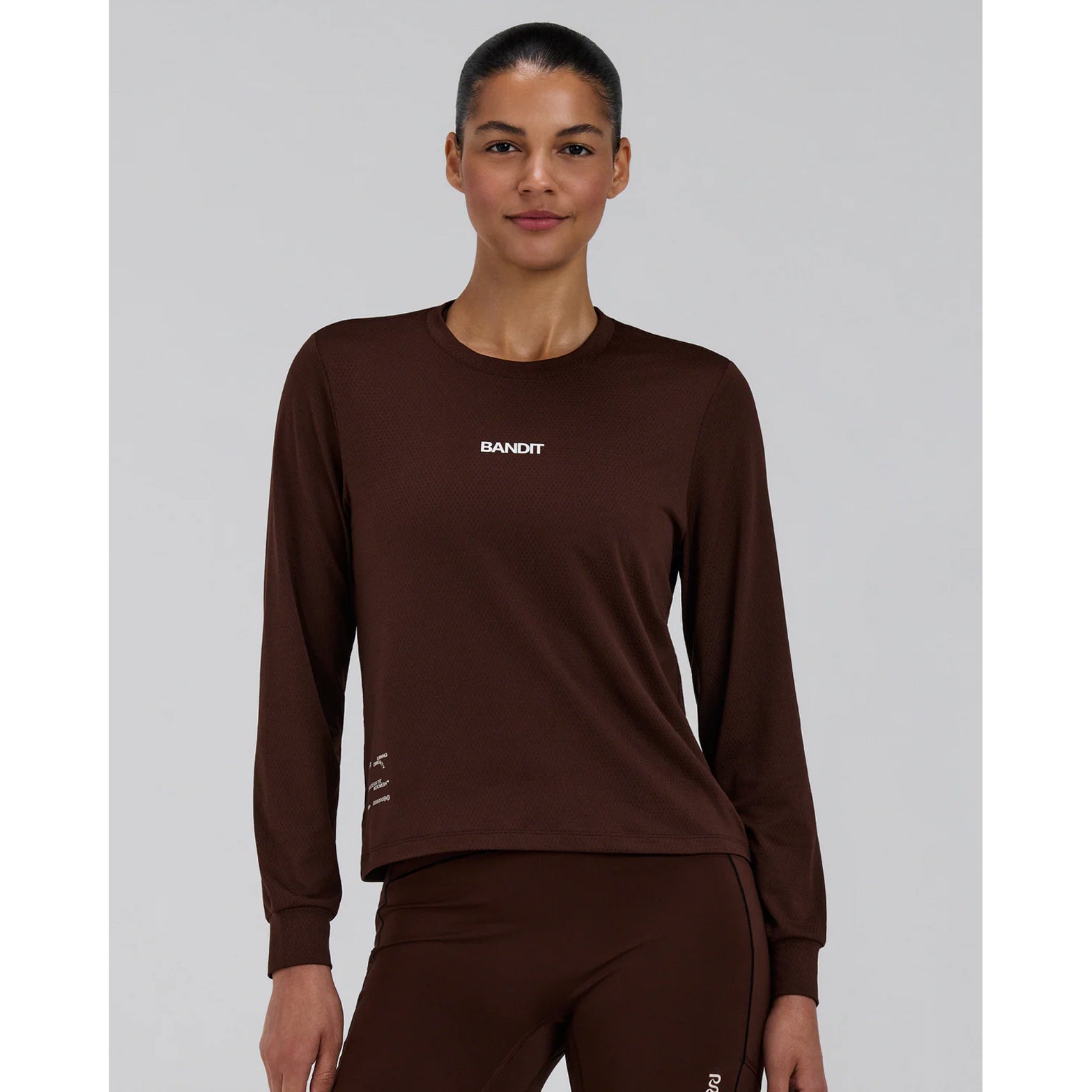 Women's Bandit Micromesh Top Cacao front view on female model showing relaxed silhouette with sweat-wicking Oeko-Tex Certified mesh and dyed-to-match reflective graphic