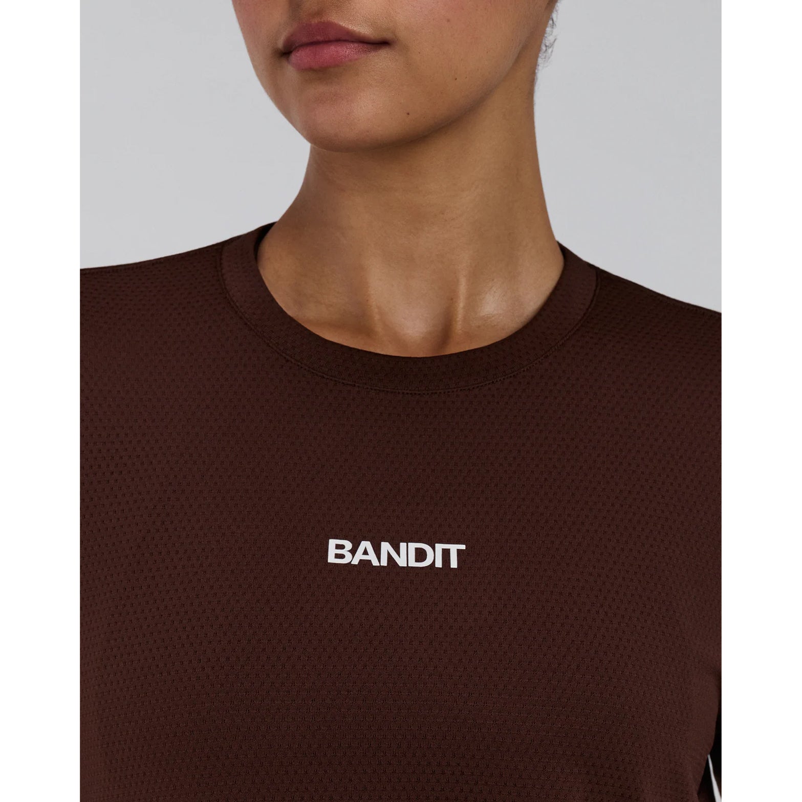 Women's Bandit Micromesh Top Cacao close-up front showing moisture-wicking quick-drying Micromesh fabric with reflective infographic at front hem