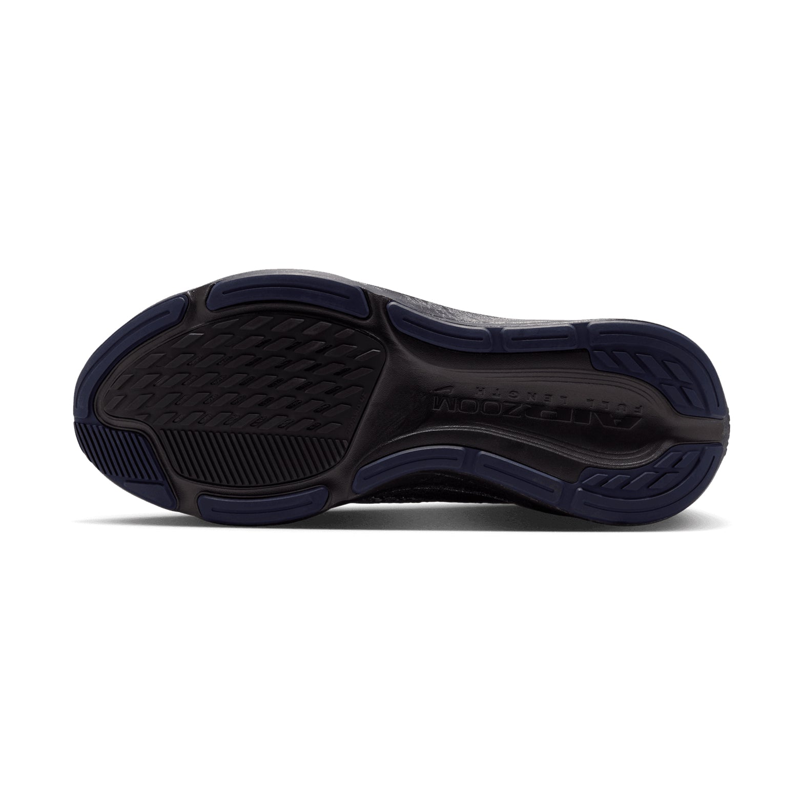 The image displays the dark-colored sole of the Nike Women’s Pegasus 42 Keely Hodgkinson Running Shoes in Black / Pitch Blue / Blackened Blue / Blur, as seen from below. The tread exhibits textured rubber segments designed for grip and flexibility, with the REACT ZOOM branding visible near the heel—a signature feature of this model enhanced with Air Zoom cushioning.