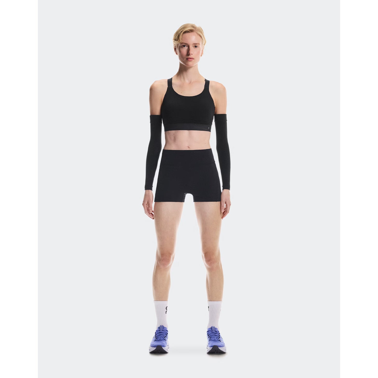 Women's On Performance Bra Black full body front view on female runner showing medium support pull-on design with On DryTec technology for moisture management