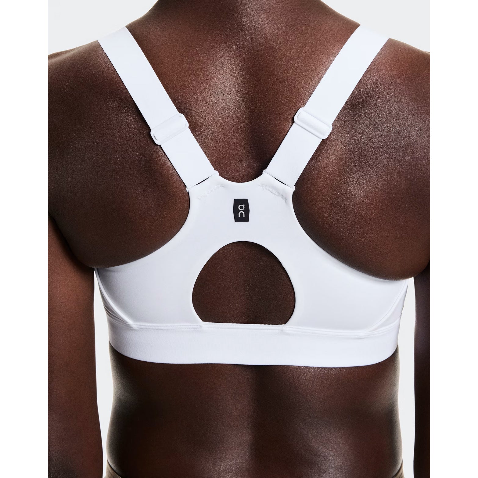 Women's On Performance Bra White back view on female runner showing breathable mesh racerback inserts for airflow and back-positioned strap adjusters