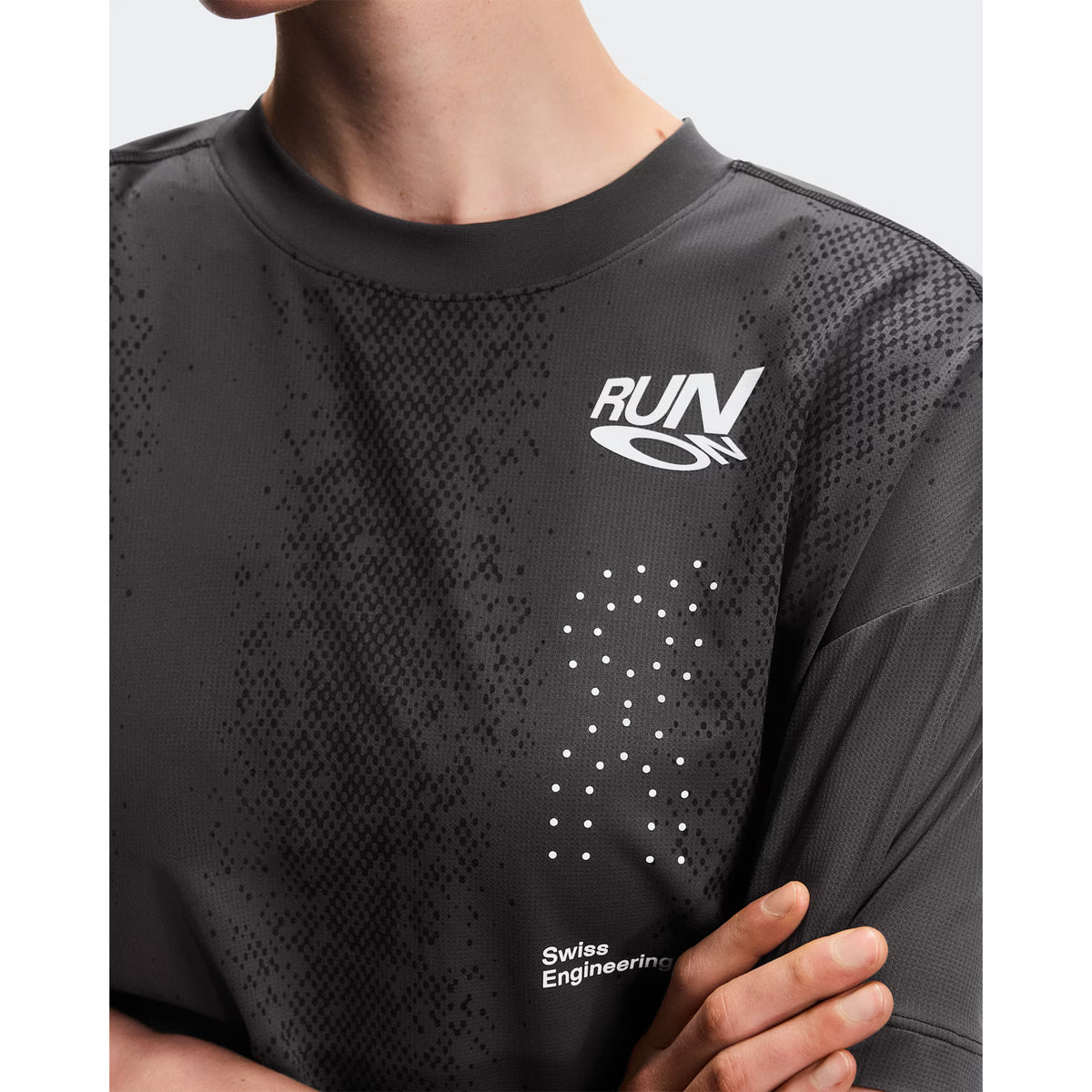 Women's On Performance Volt-T Iron close-up front showing expressive run-culture graphics with typographic elements and quick-drying fabric construction