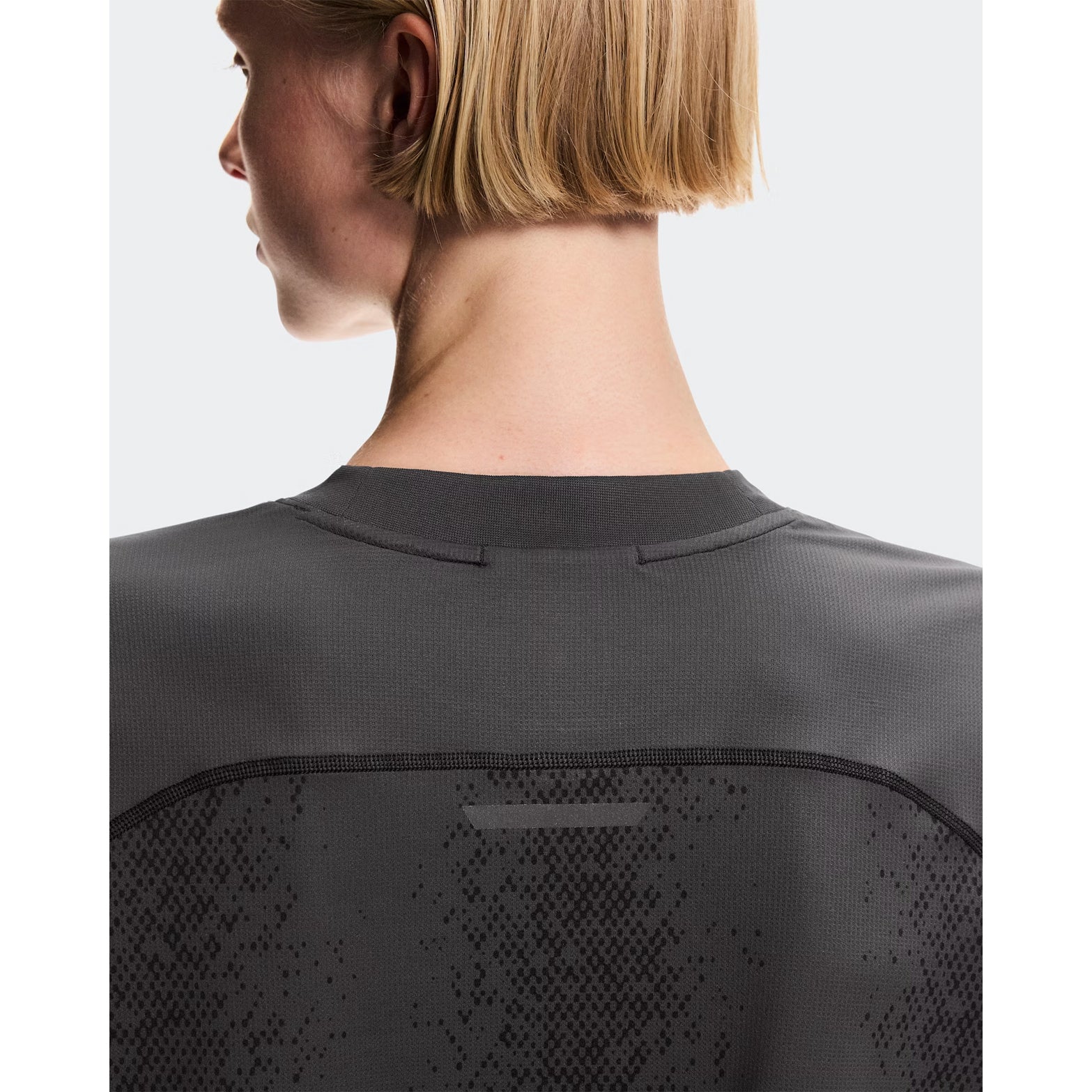 Women's On Performance Volt-T Iron back view on female runner showing relaxed fit with On DryTec technology for versatile training and recovery wear