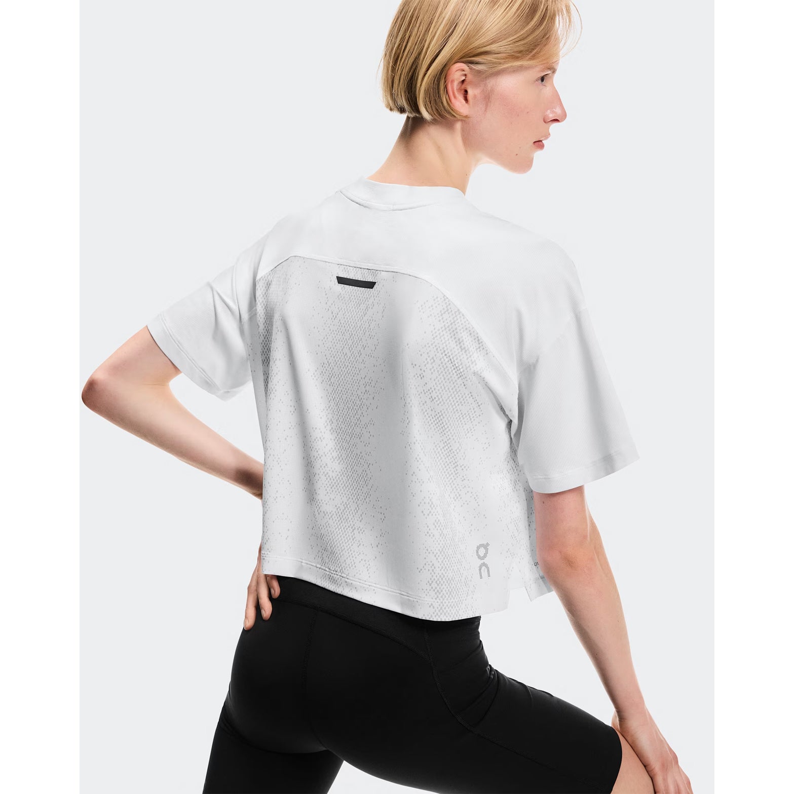 Women's On Performance Volt-T White back view on female runner showing relaxed fit with On DryTec technology for versatile training and recovery wear