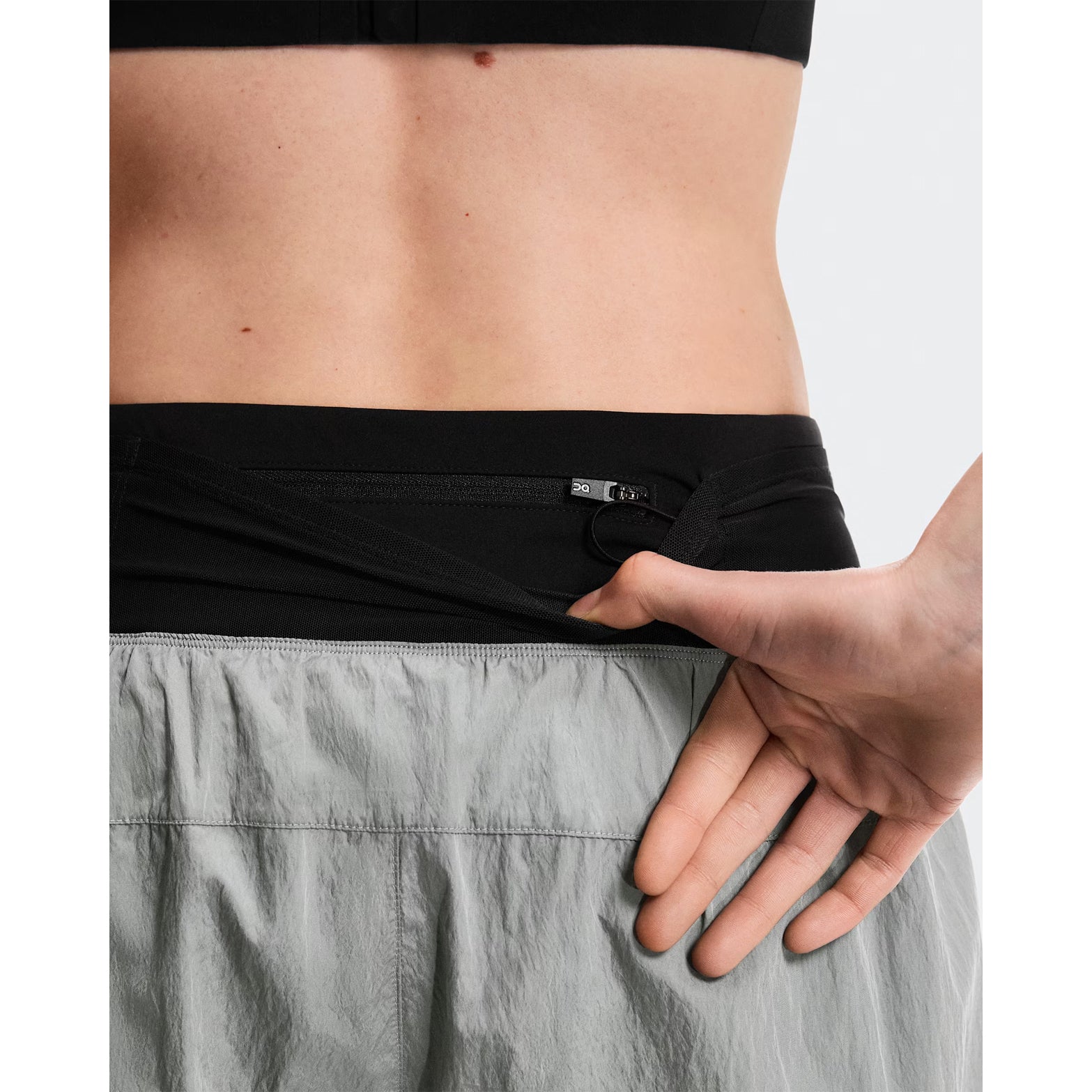 Women's On Performance Volt Shorts Glacier back view on female runner showing additional back pocket for storage and windproof water-repellent outer construction