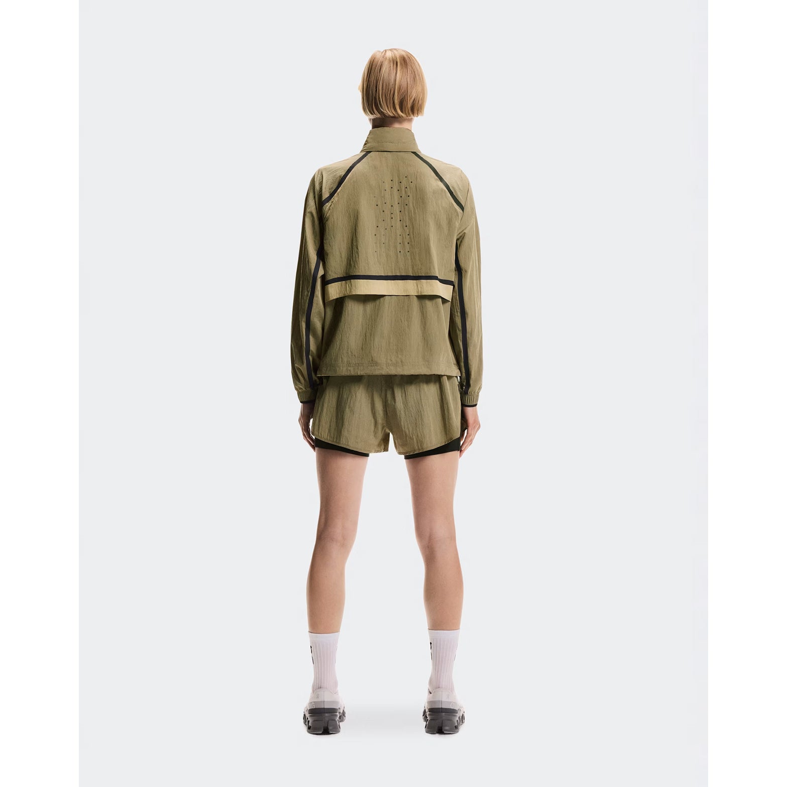 Women's On Performance Volt Shorts Safari full body back view on female runner showing additional back pocket storage and water-repellent iridescent outer layer