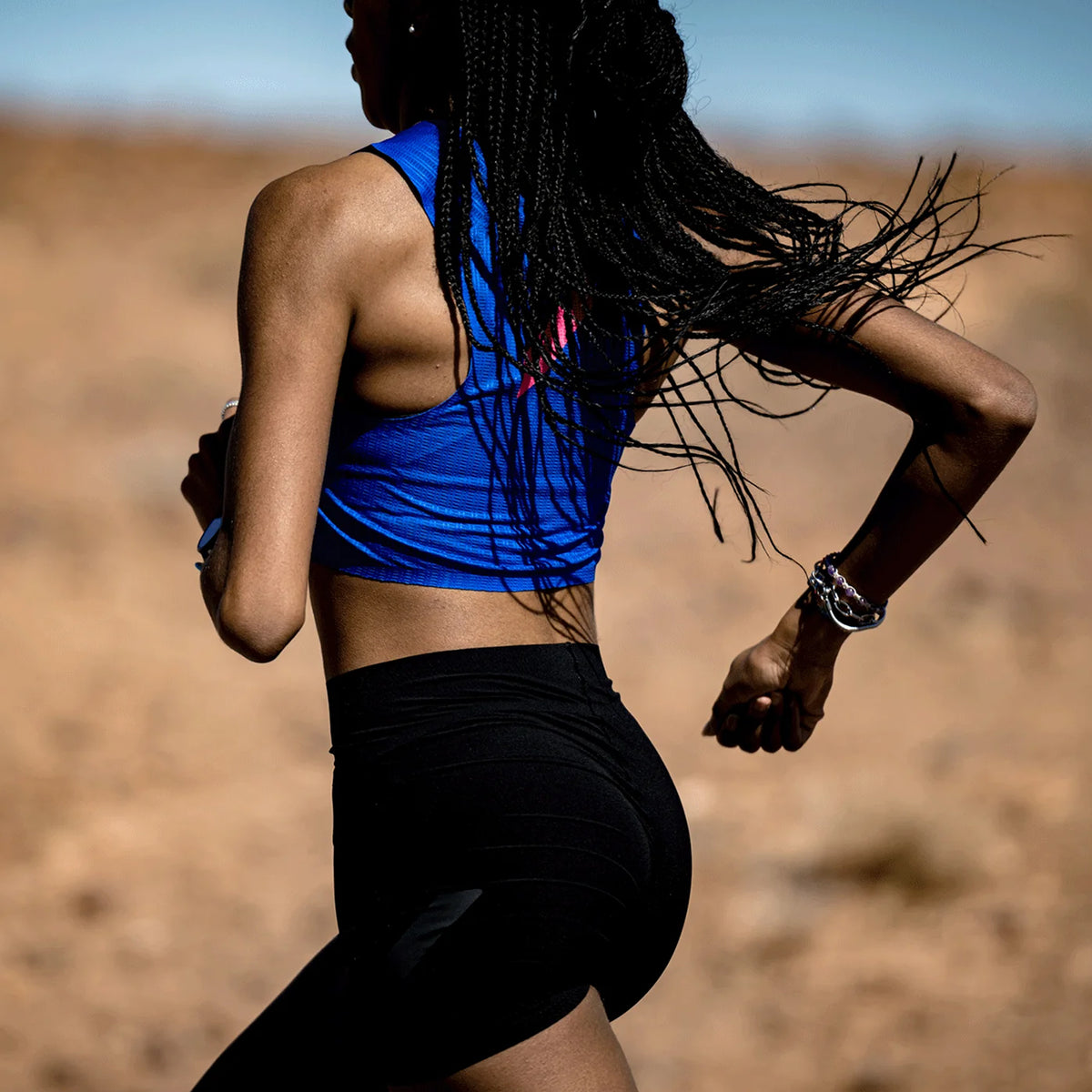 Soar Speed Shorts women's in Black — side view worn by female runner showing three-panel hip-to-waist fit, higher waist construction and reflective Soar logo