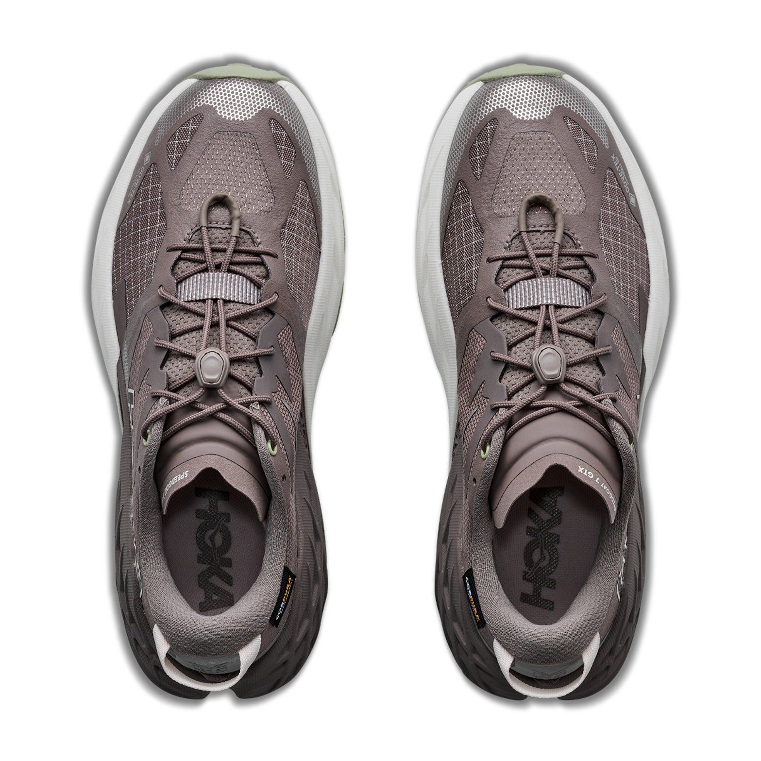 A top view of a pair of Women’s Speedgoat 7 GORE-TEX Trail Running Shoes by Hoka in Pebble Grey and Alabaster, featuring mesh uppers, distinctive lacing systems, and white soles, arranged side by side on a white background.