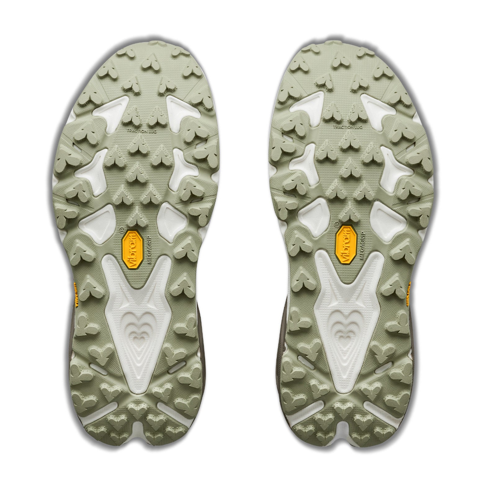 Two light green and white Vibram outsoles from the Hoka Women’s Speedgoat 7 GORE-TEX Trail Running Shoes in Pebble Grey / Alabaster, featuring textured heart-shaped and triangular treads, are displayed side by side on a white background.