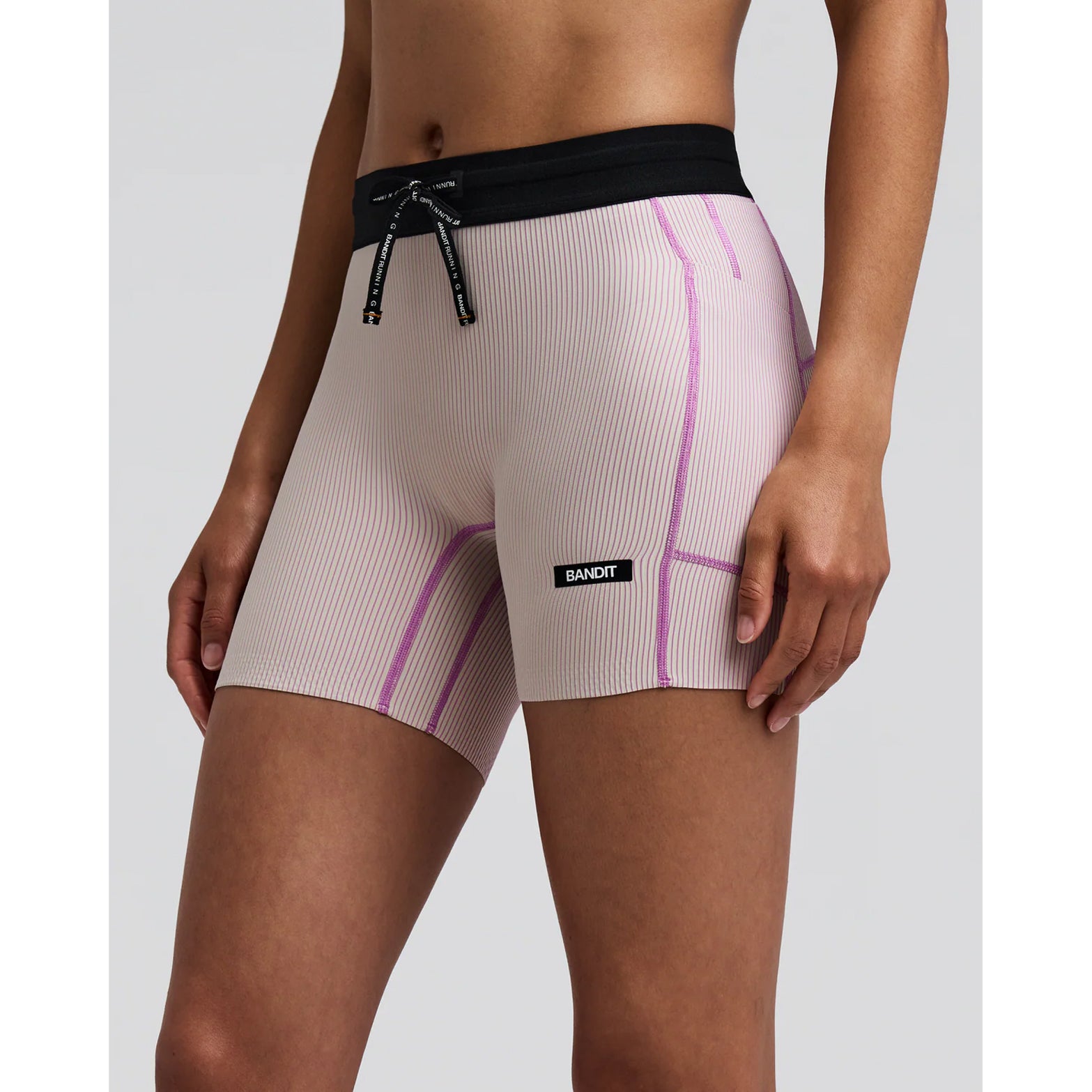 Women's Bandit Striped Cadence 5 Inch Compression Shorts Plaster Orchid side view on female runner showing 5-inch inseam with ultra-compressive Striped Cadence ribbed knit and custom anti-chafe waistband for comfortable race day performance