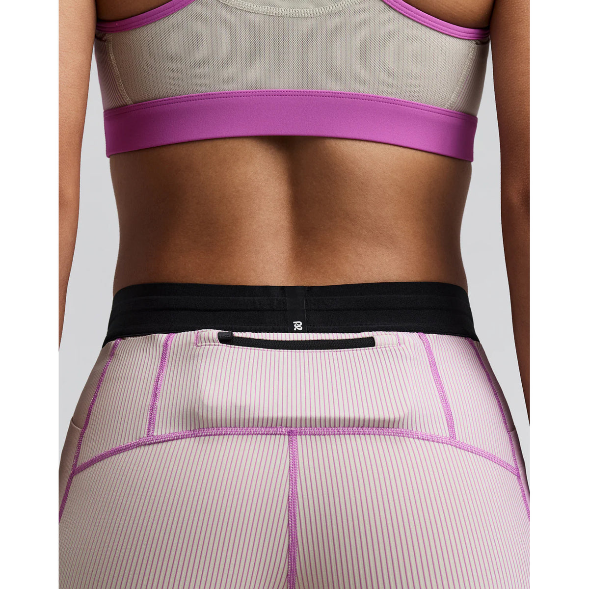 Women's Bandit Striped Cadence 5 Inch Compression Shorts Plaster Orchid close-up of back showing back zipper pocket with grip tape hem technology and subtle silicone logo detailing