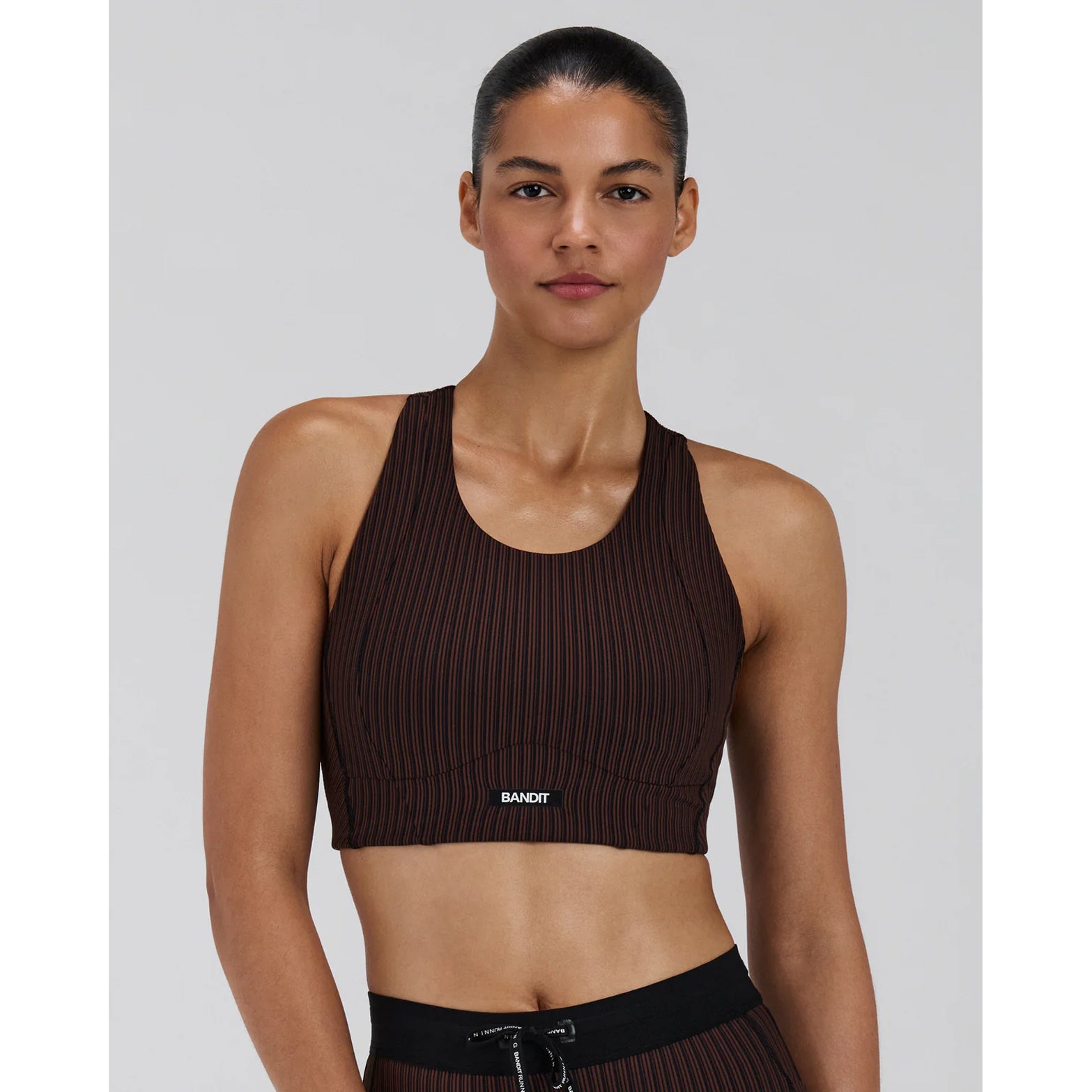 Bandit Striped Cadence Longline Bra women's in Cacao / Black — front view worn on model showing longline fit, cacao and black Striped Cadence™ ribbed knit and double-layer support construction