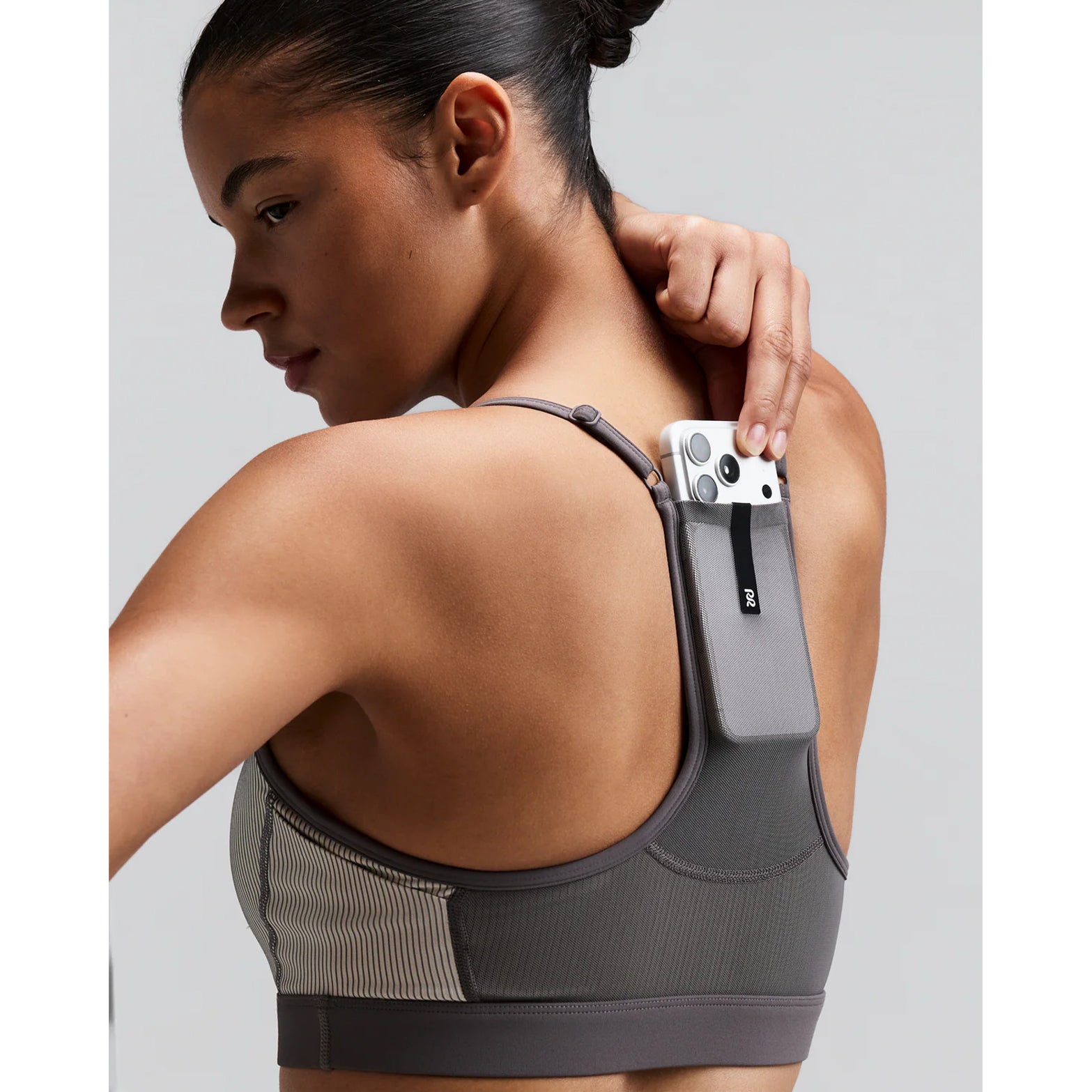 Women's Bandit Striped Cadence Strappy Bra Plaster Slate close-up of waterproof centre back phone pocket showing secure hidden storage with zero-bulk design for race day essentials without bounce