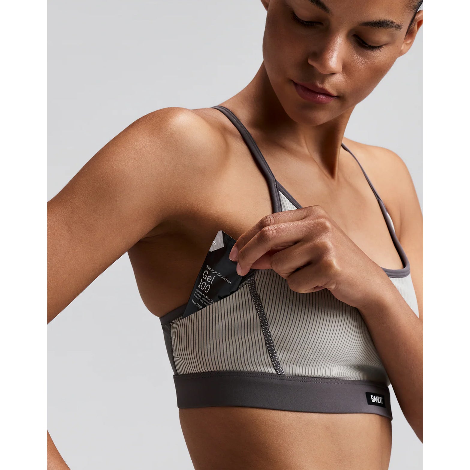 Women's Bandit Striped Cadence Strappy Bra Plaster Slate close-up of gel pocket under arm showing secure accessible storage for race day nutrition without bounce during running