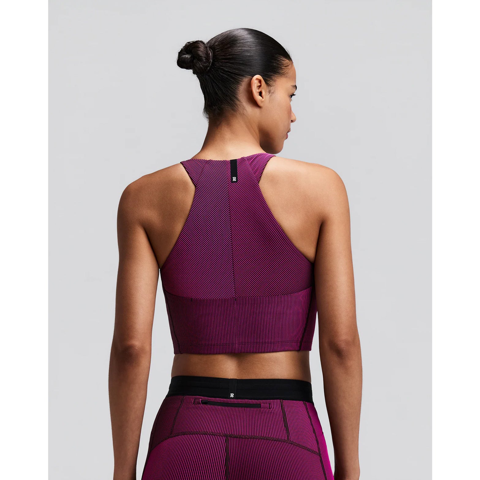 Women's Bandit Striped Cadence Zip Front Race Crop Espresso Azalea back view on female runner showing angular racer back with silicone centre back patch and smooth anti-chafe seam construction