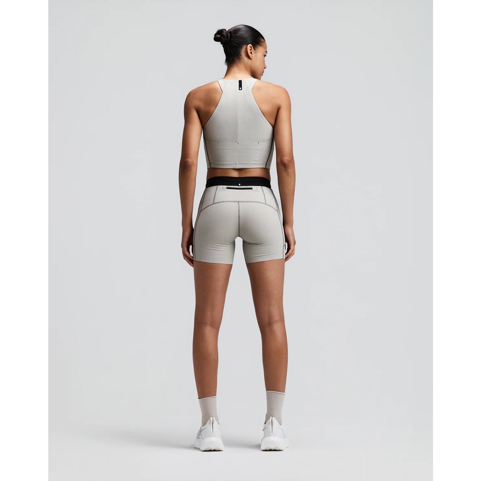 Women's Bandit Striped Cadence Zip Front Race Crop Plaster Slate back full body view on female runner showing angular racer back with silicone patch and Striped Cadence ribbed compression for race day performance