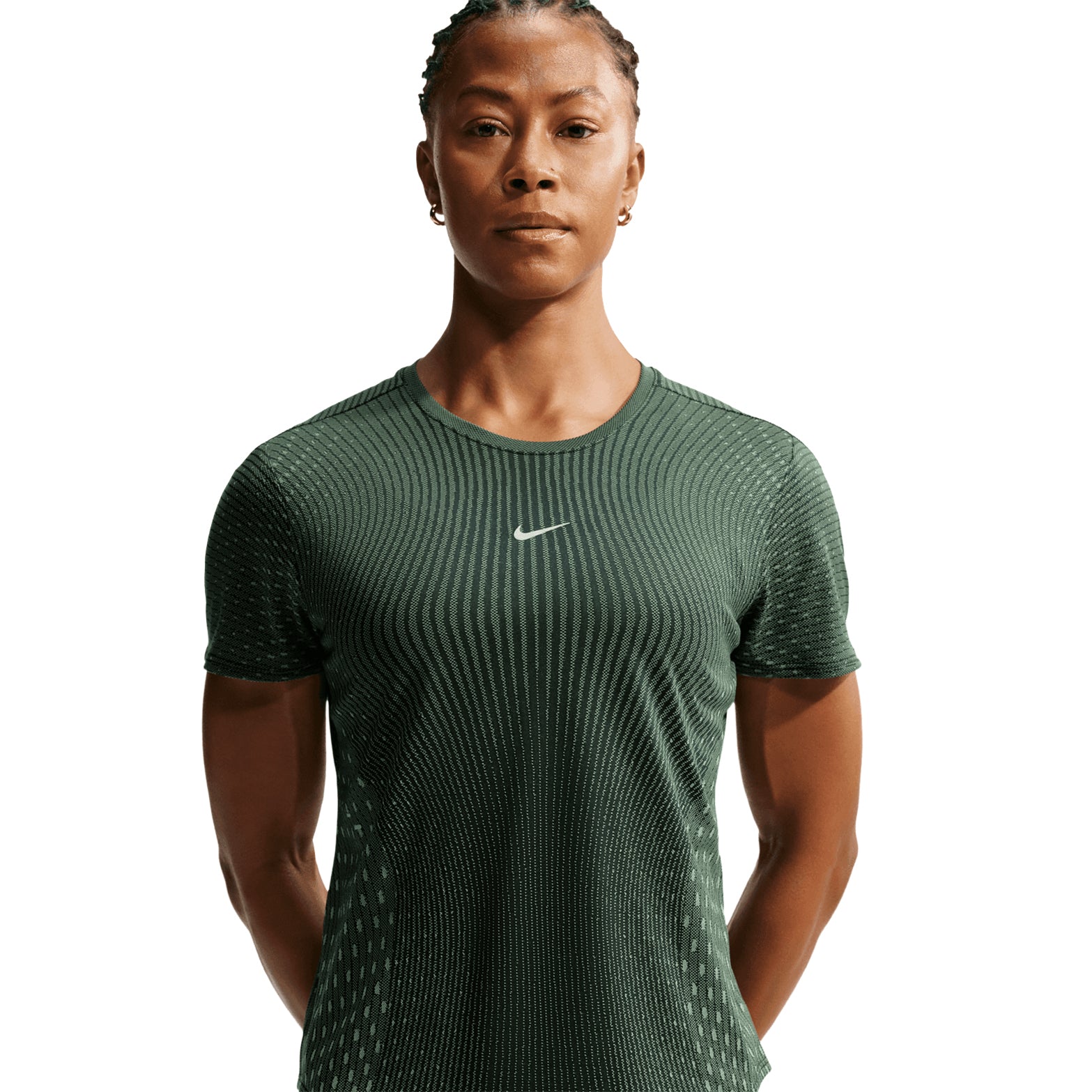 A person stands facing forward, wearing a fitted Nike Women’s Swift Aero-FIT Running Tee in Black / Light Green Spark with subtle stripes and short sleeves, against a plain white background.