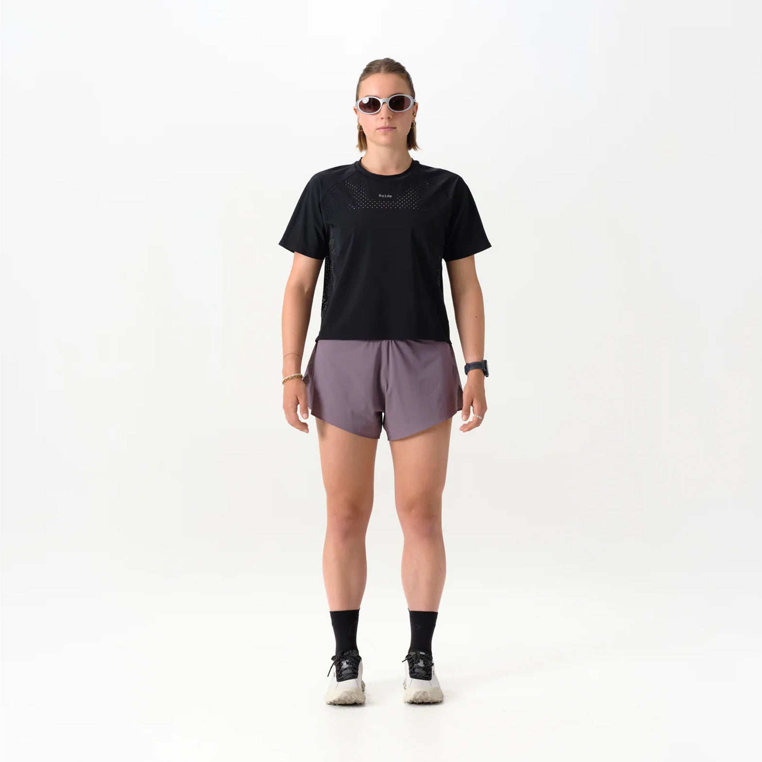 Women's Raide Thermal Dispersion Tee Black front full body view on female runner showing cool-to-touch Italian microfibre with four-way stretch and body-mapped perforations for lightweight warm weather training