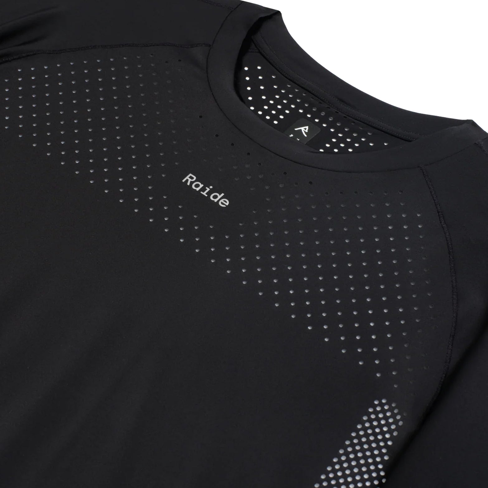 Women's Raide Thermal Dispersion Tee Black close-up of front showing reflective Raide branding with body-mapped laser-cut perforations and cool-to-touch 115gsm Italian-knit microfibre construction