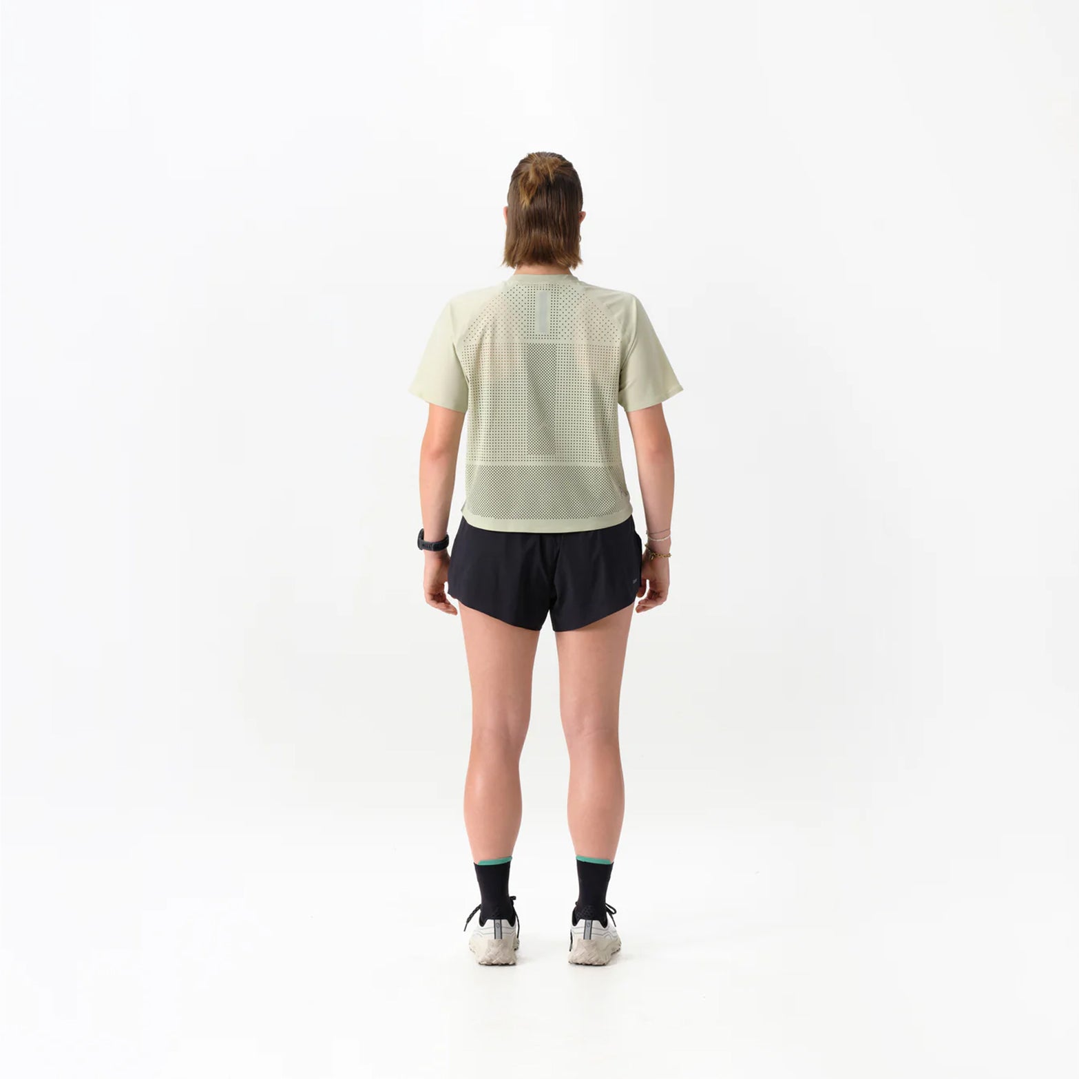 Women's Raide Thermal Dispersion Tee Lichen back full body view on female runner showing body-mapped centre back perforations with reflective branding and Italian-knit microfibre for evaporative cooling during road running