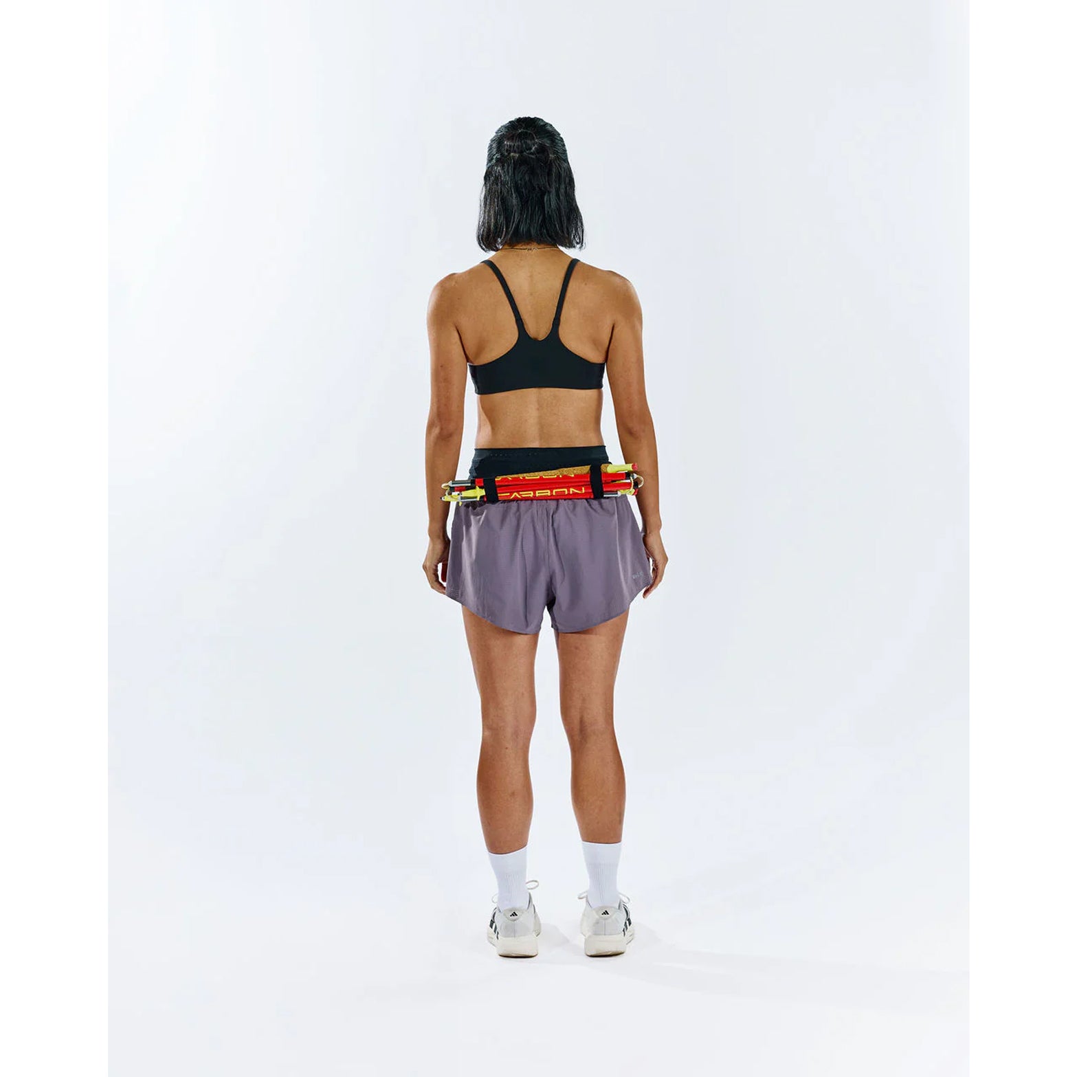 Raide TrailTech Short women's in Dusk — full body back view worn on model showing large rear pocket placement, zippered pocket detail and Toray DotAir outer construction in motion on trail