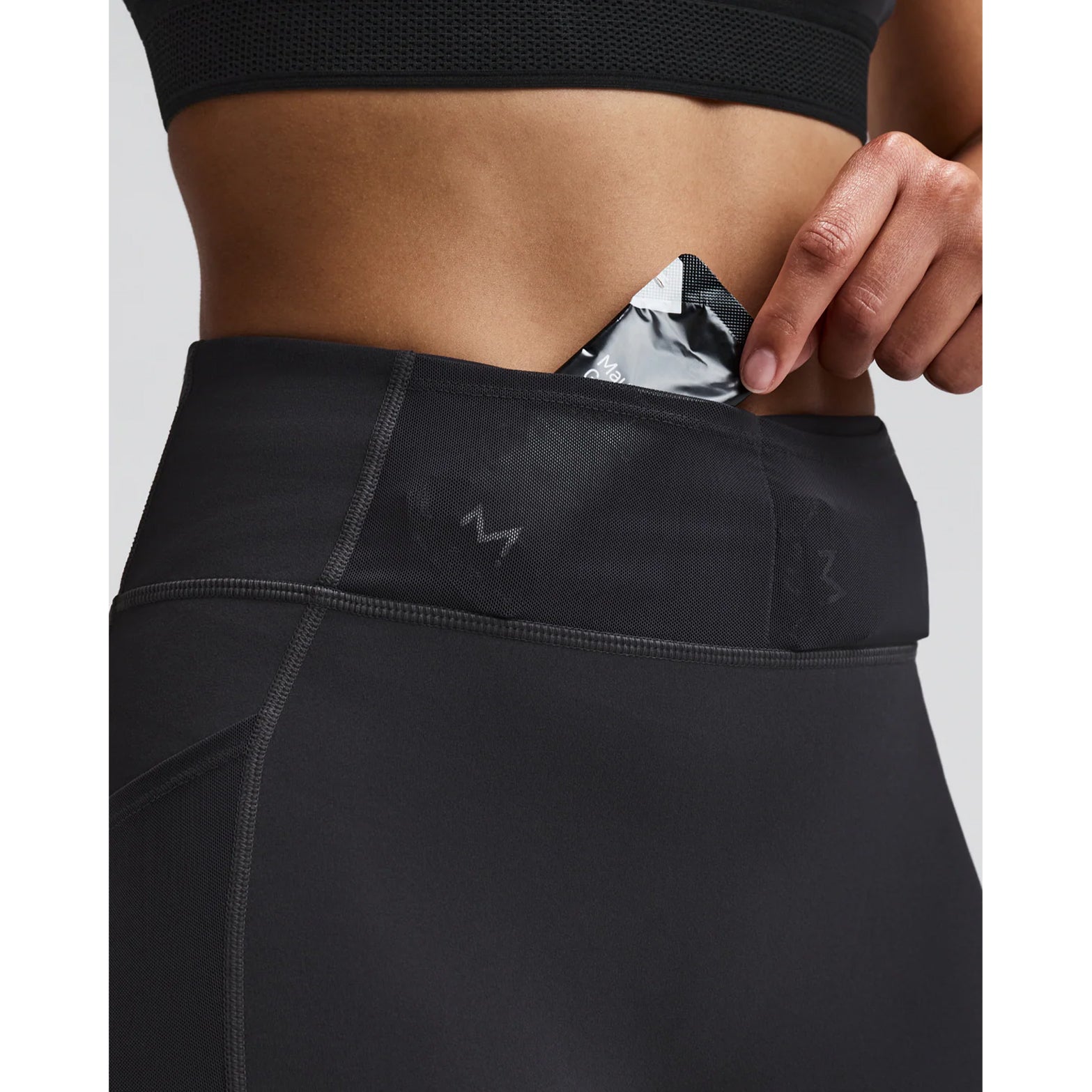 Women's Bandit Vanisher 5 Inch High Waist Compression Shorts Anthracite close-up of Powermesh gel pocket showing horizontal storage for two gels with secure fast-access design for race day nutrition