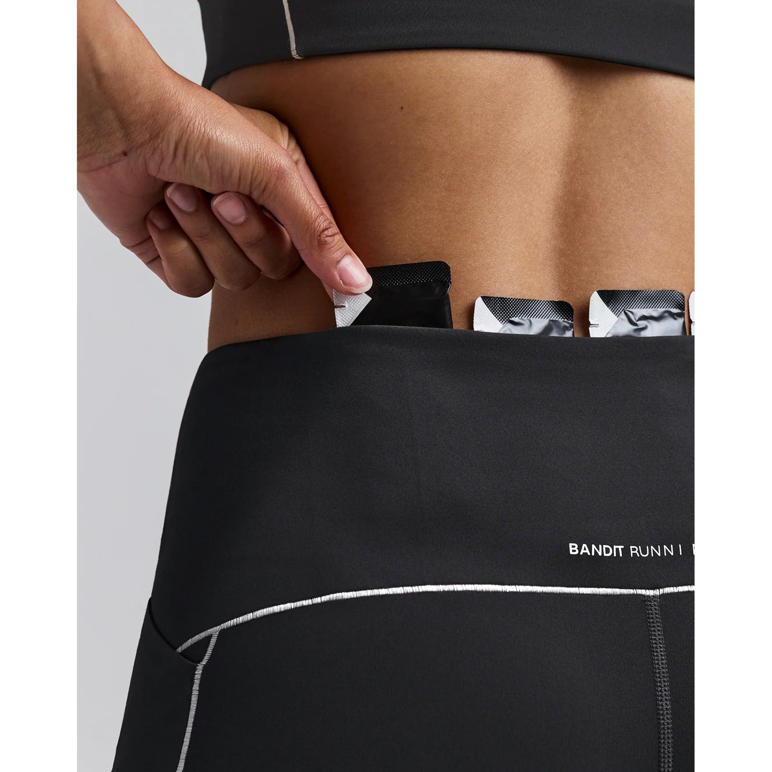 Women's Bandit Vanisher Pop Stitch 5 Inch High Waist Compression Shorts Anthracite close-up of Powermesh gel pocket showing horizontal storage for two gels with secure fast-access design for race day nutrition
