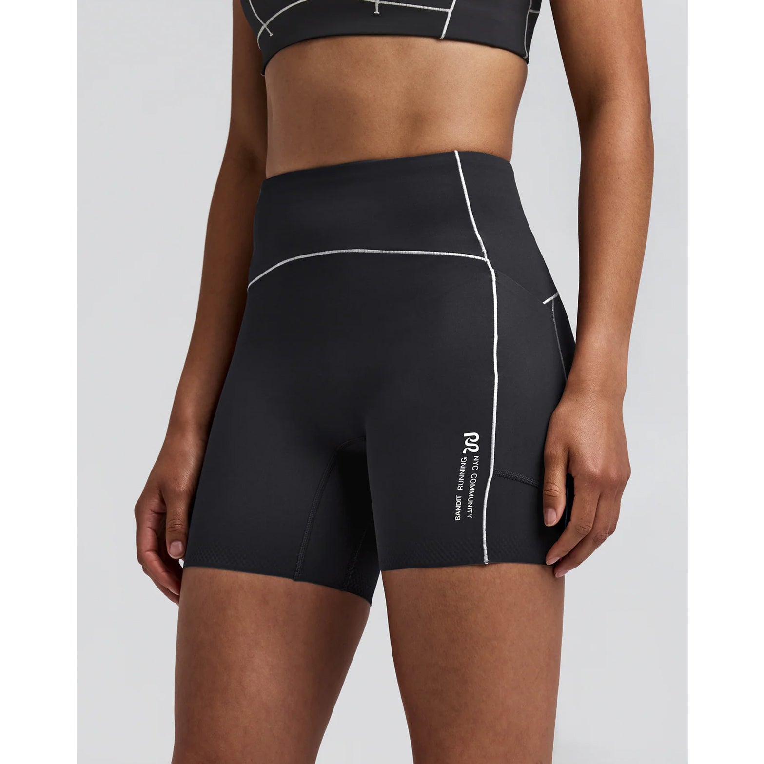 Women's Bandit Vanisher Pop Stitch 5 Inch High Waist Compression Shorts Anthracite side view on female runner showing high waist Vanisher compression with waterproof side leg phone pocket and GripDot hem for comfortable race day performance
