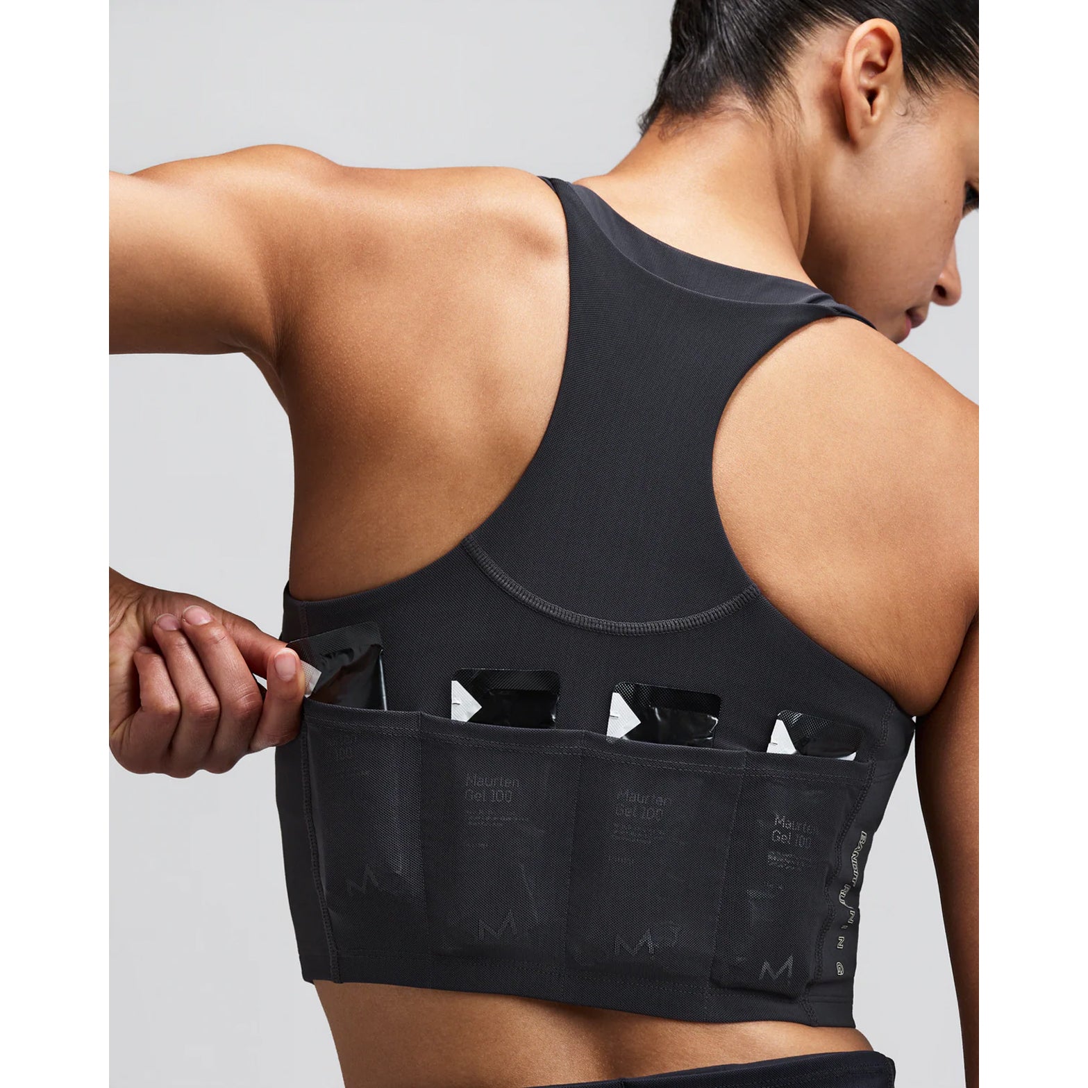 Women's Bandit Vanisher V-Neck Race Crop Top Anthracite close-up of pocket system showing three waterproof phone pockets and four gel pockets with zero-bulk design for race day essentials