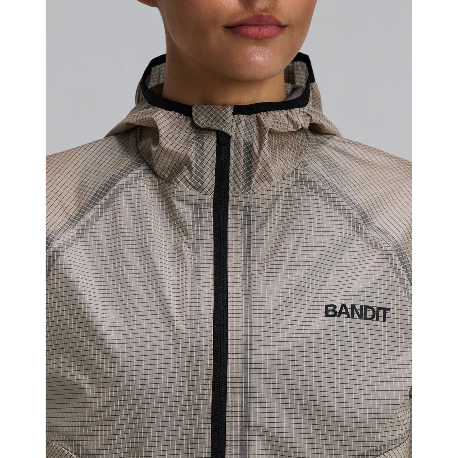 Women's Bandit VeloRip Ultralight Windproof Jacket Oatmeal close-up front showing reflective logo detail on fully windproof water-repellent fabric
