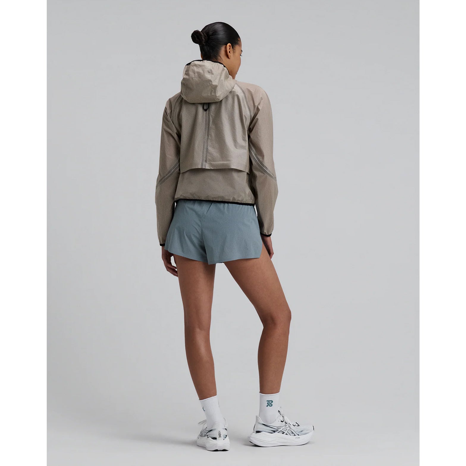 Women's Bandit VeloRip Ultralight Windproof Jacket Oatmeal full body back view on female runner showing ultra-light featherweight design with bonded seamless construction