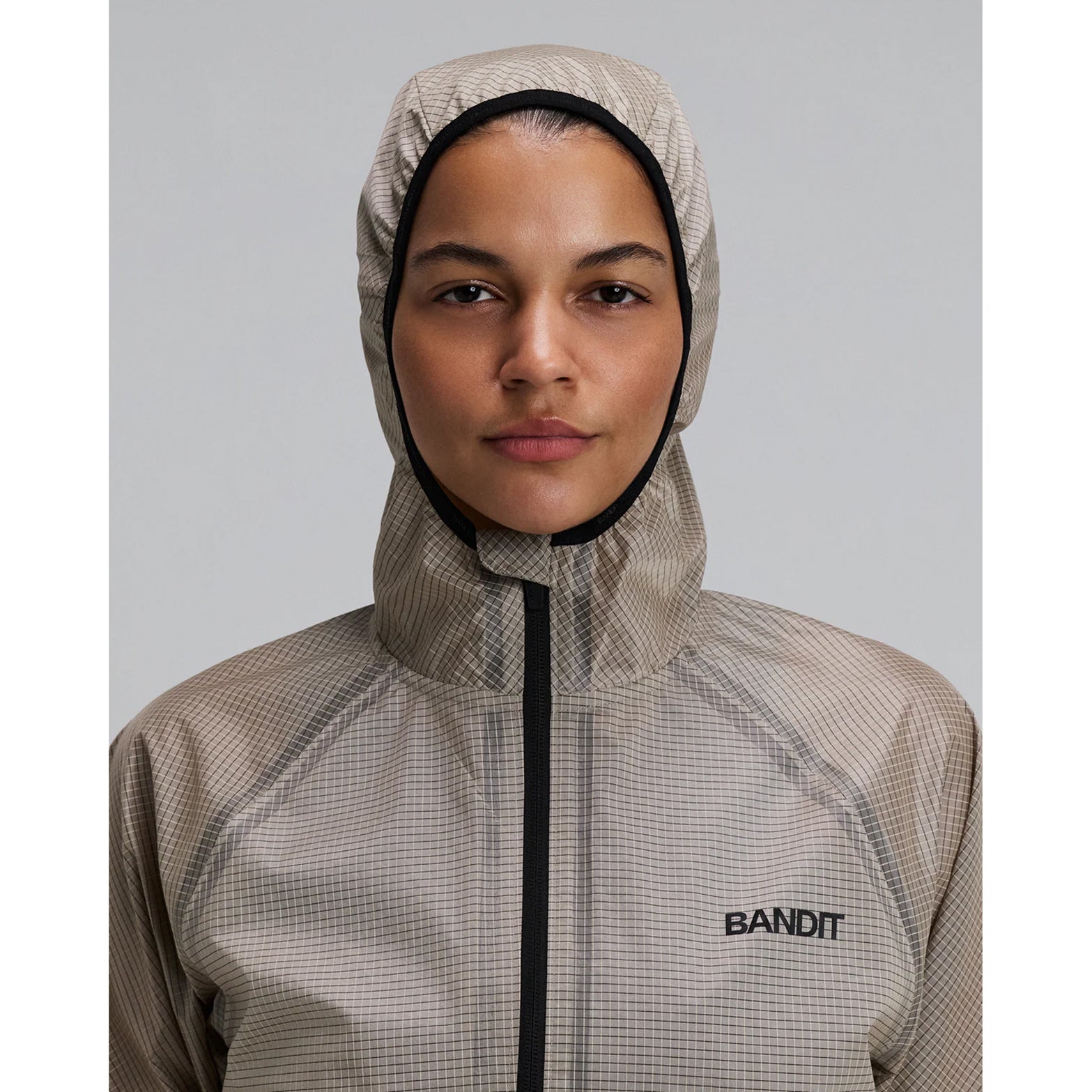 Women's Bandit VeloRip Ultralight Windproof Jacket Oatmeal front view with hood up showing weather protection with minimal construction and 2-way zipper