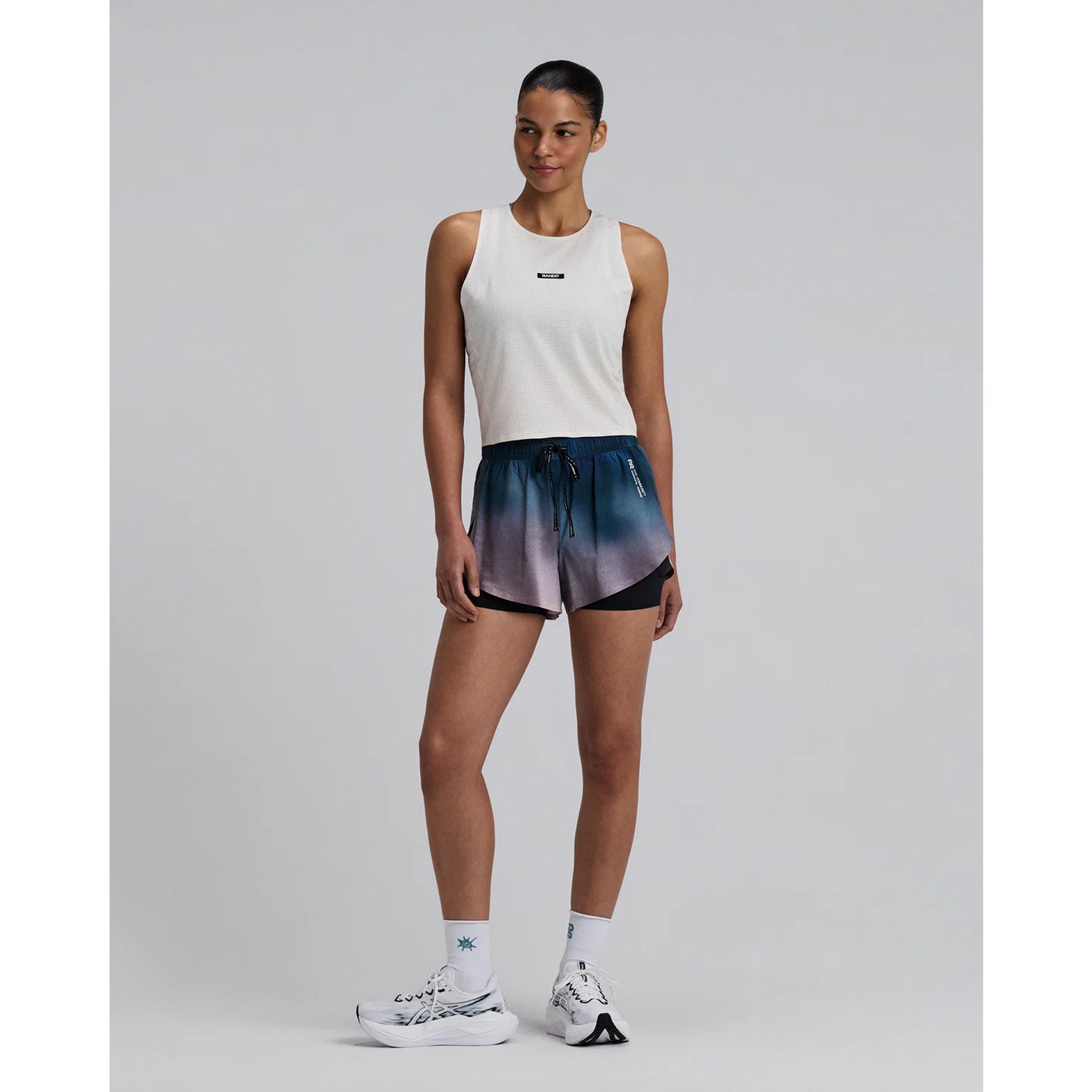 Bandit Vento™ 2-in-1 Run Short women's in Flow State Aegean Multi — full body front view worn on model showing 2-in-1 silhouette, flow state aegean multi Vento™ micro-perforated fabric and reflective Bandit branding in motion