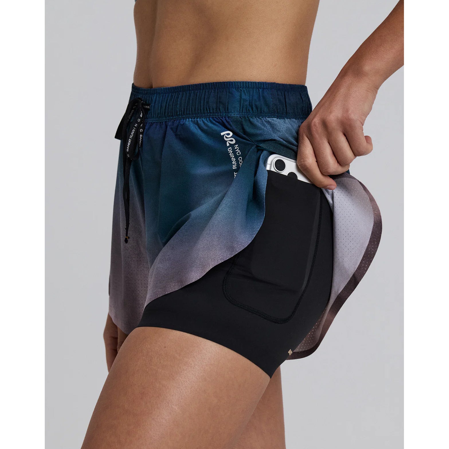 Bandit Vento™ 2-in-1 Run Short women's in Flow State Aegean Multi — side view worn on model showing waterproof phone pocket placement and flow state aegean multi Vento™ micro-perforated fabric profile