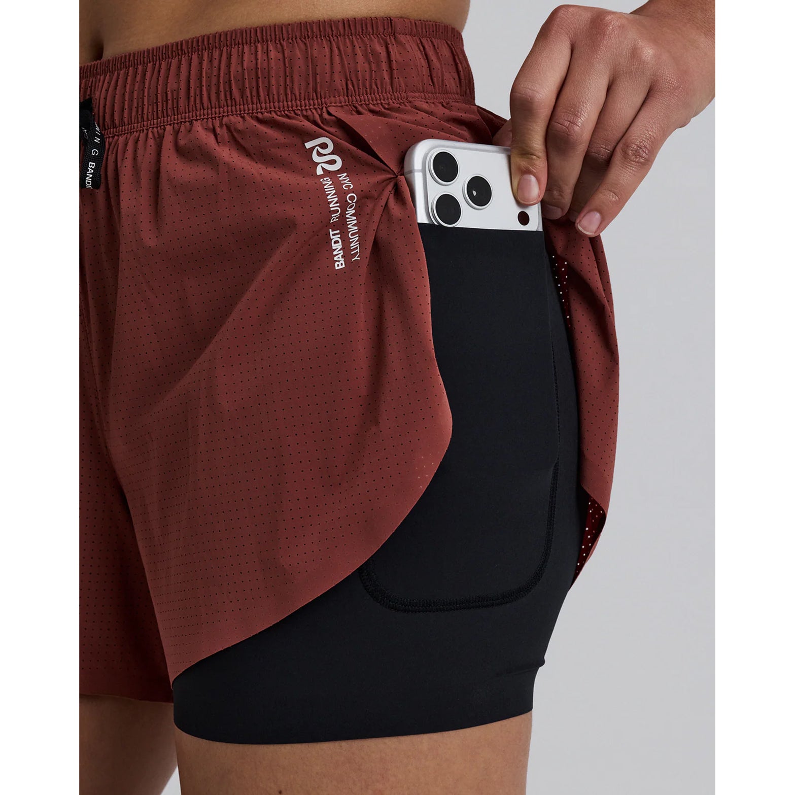Women's Bandit Vento 2-in-1 Run Short Mahogany Black close-up of waterproof phone pocket with sweat-proof protection for device storage