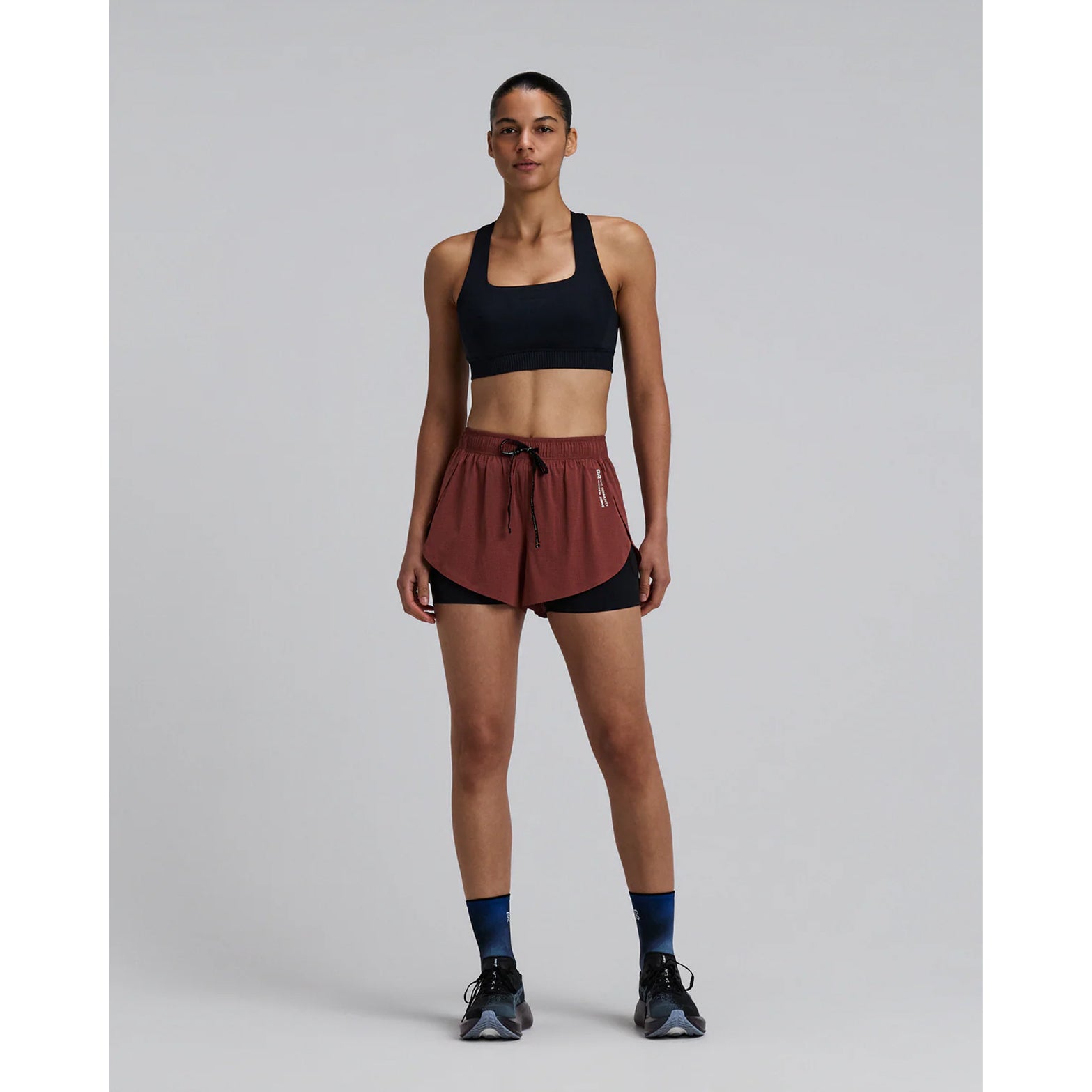Women's Bandit Vento 2-in-1 Run Short Mahogany Black full body front view on female runner showing breathable micro-perforated fabric with SoLite compression liner