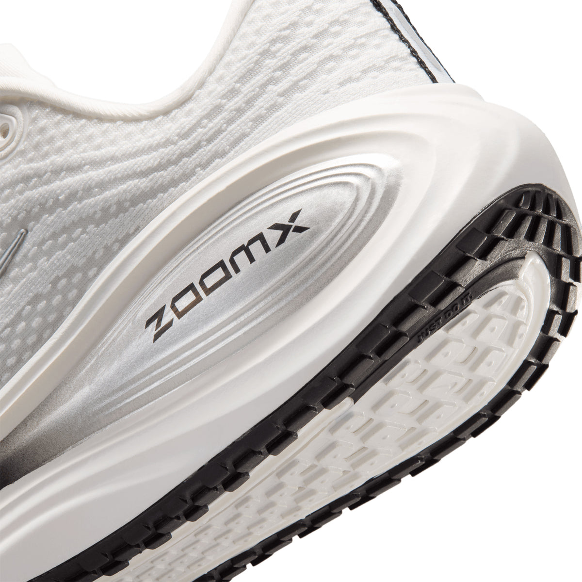 Women's Nike Vomero Plus ESS Running Shoes Summit White Sail Anthracite Metallic Silver angled side and heel view showing full-length ZoomX foam with high-abrasion outsole and soft breathable mesh upper for maximum cushioned everyday road running