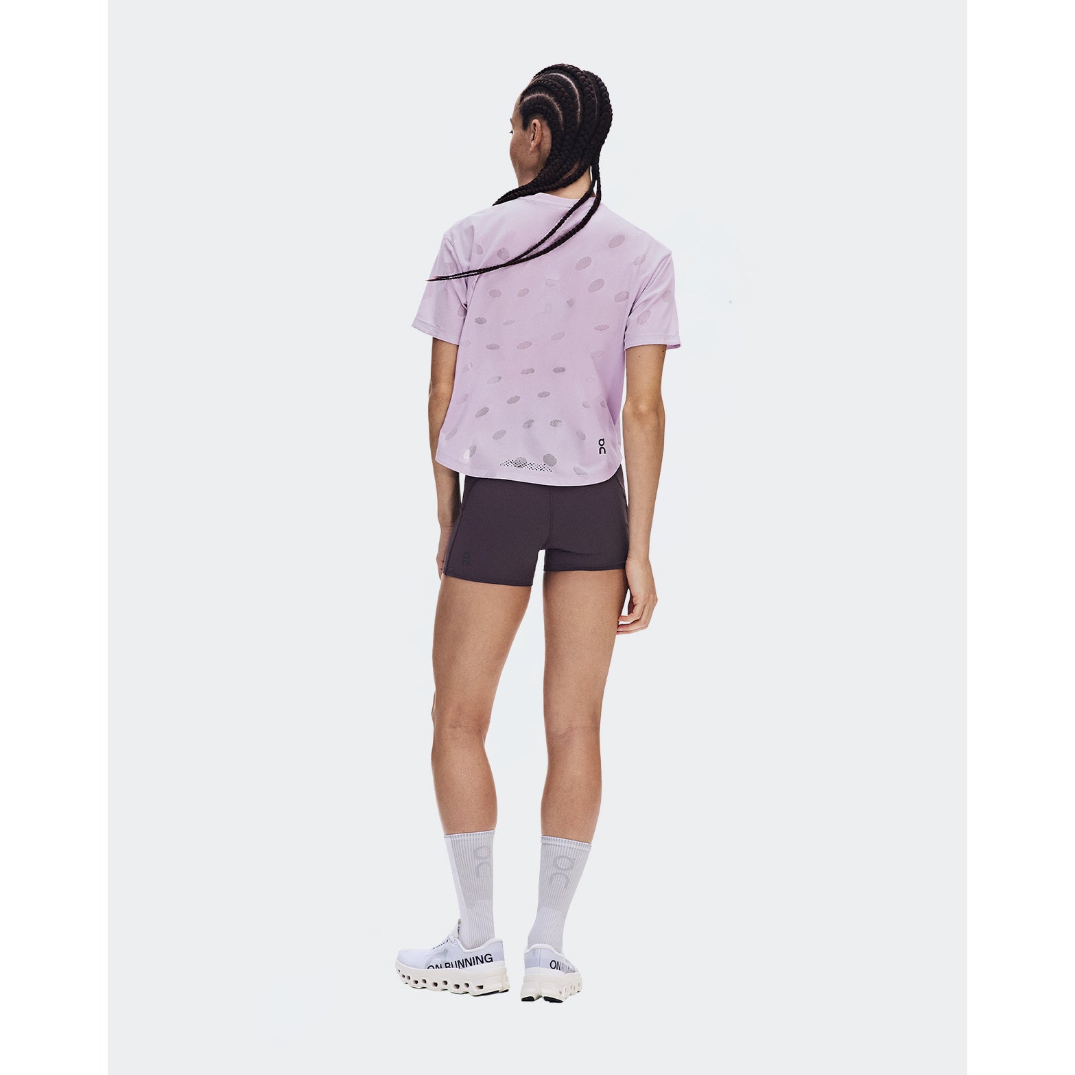 Women's On Zero-T Breathe Foxglove back full body view on female runner showing reflective detailing with minimalist jacquard construction and On DryTec quick-drying fabric for training runs