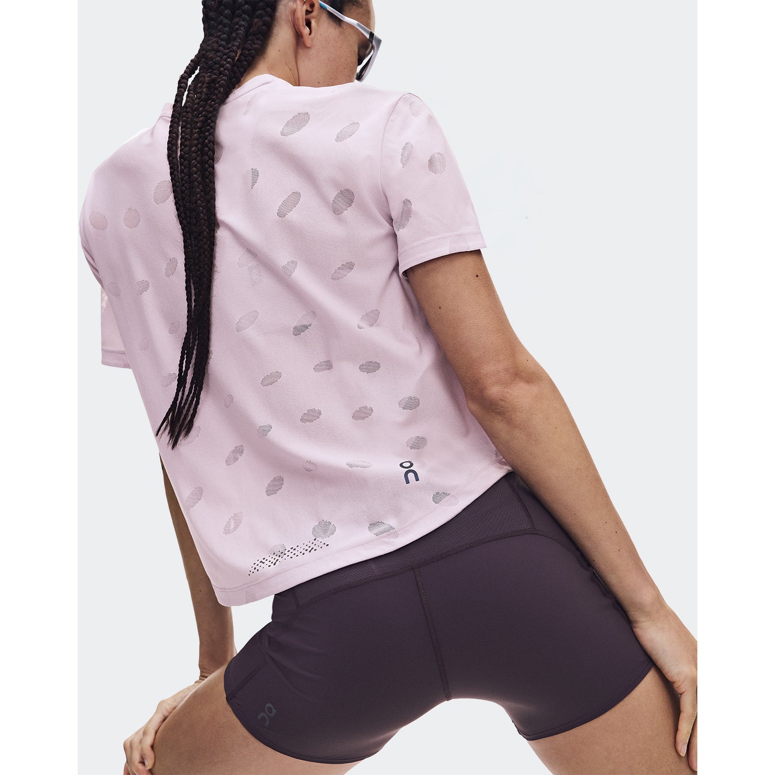 Women's On Zero-T Breathe Foxglove back view on female runner showing reflective detailing with functional jacquard fabric and On DryTec moisture-wicking construction