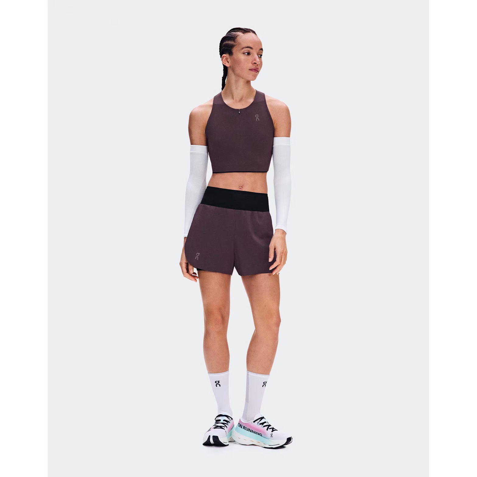 Women's On Zero 2-in-1 Shorts Urchin Black front full body view on female runner showing 2-in-1 construction with ultralight perforated outer and On DryTec moisture-wicking inner for high-performance training