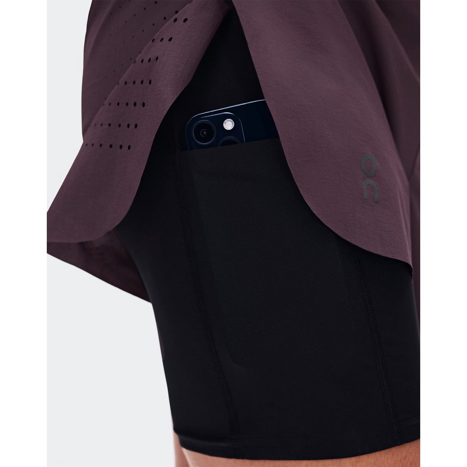 Women's On Zero 2-in-1 Shorts Urchin Black close-up of phone pocket showing secure 360° waistband storage with bounce-free design for distraction-free high-intensity training and racing