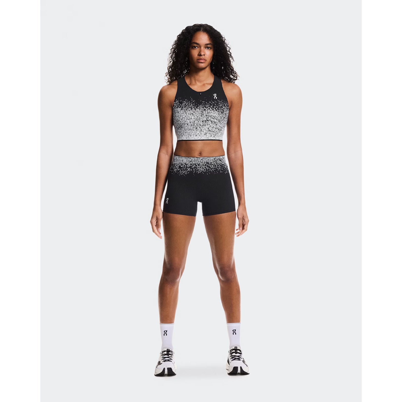 Women's On Zero Short Tights Black White full body front view on female runner showing lightweight construction and confident fit for race day performance