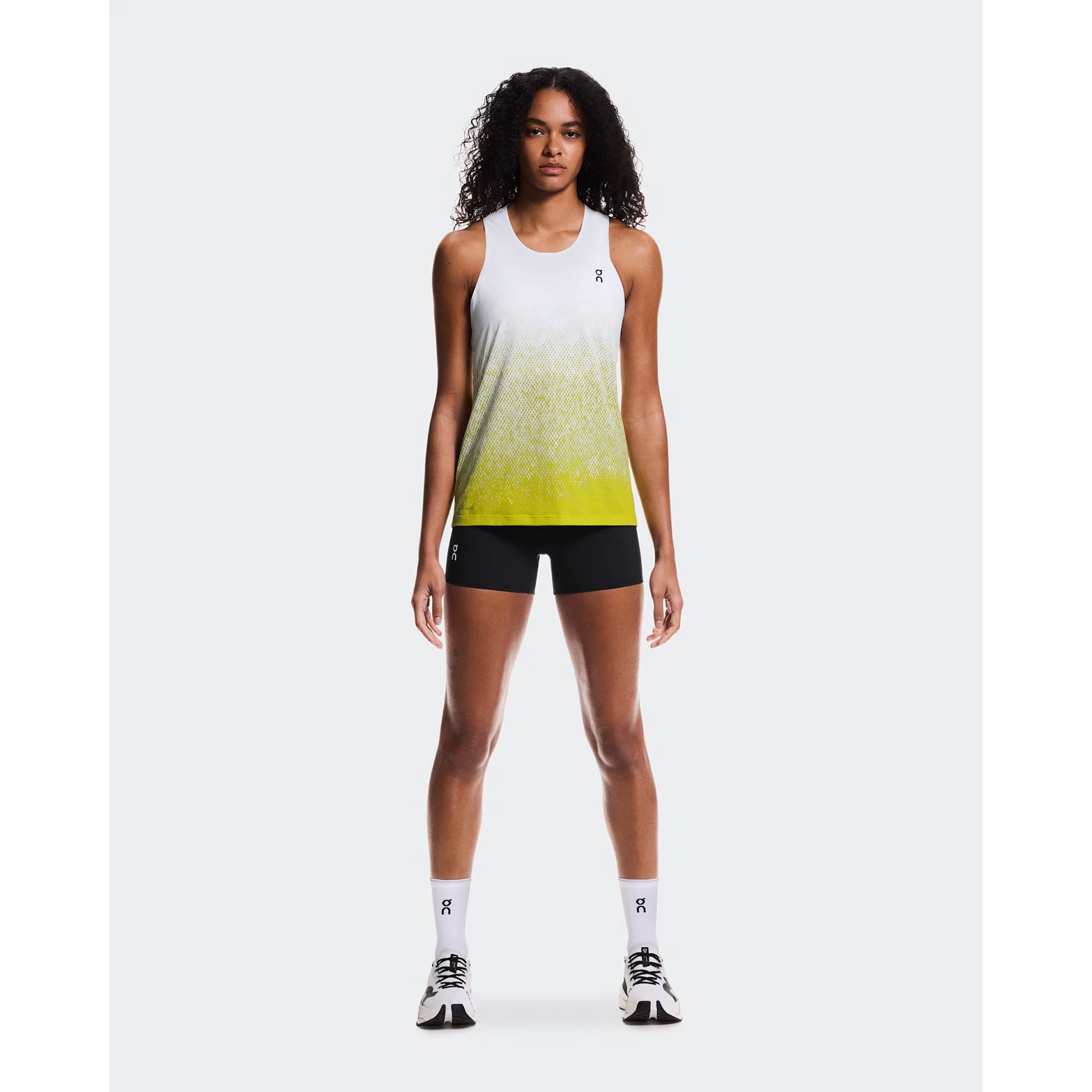 Women's On Zero Singlet White Yellow full body front view on female runner showing ultra-lightweight race day performance and On DryTec moisture-wicking technology