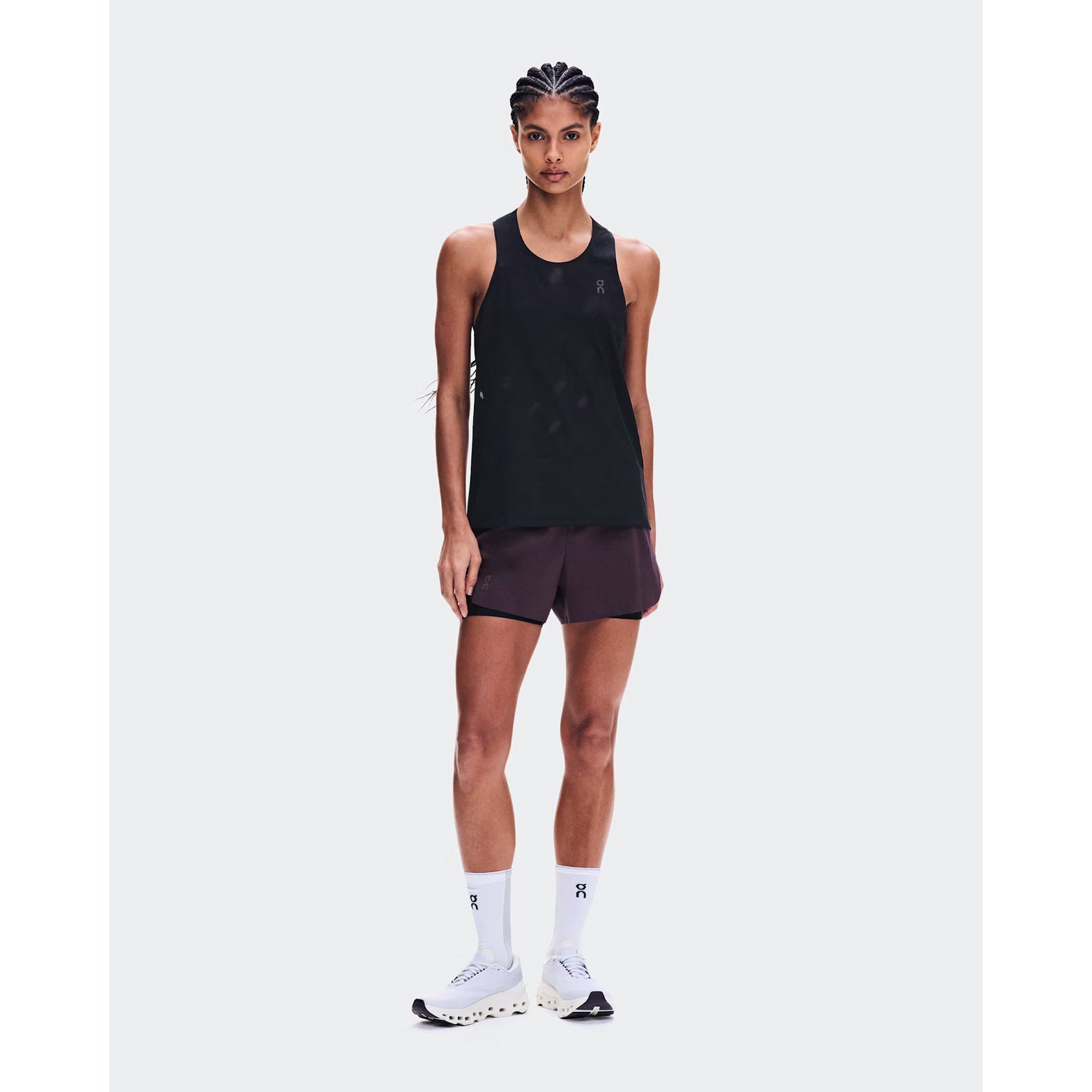 Women's On Zero Tank Breathe Black front full body view on female runner showing ultralight OAC-inspired jacquard tank with DryTec breathable construction for race day and fast training performance